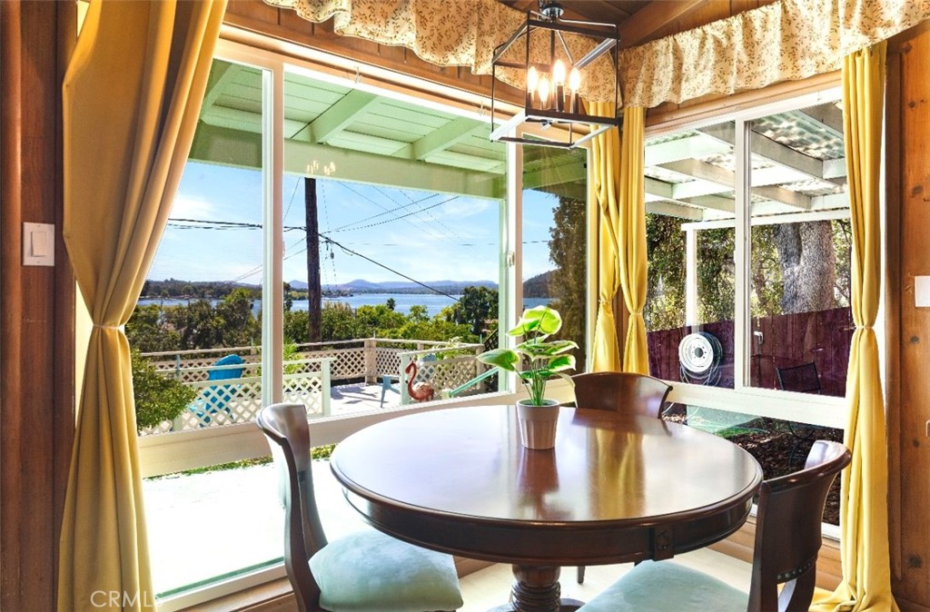 Imagine waking up to stunning lake views and feeling like you're on a permanent vacation - that's exactly what this delightful home offers! Featuring two cozy bedrooms and a well-appointed bathroom, this residence boasts an inviting open concept living room featuring a cozy fireplace that'll make your heart sing and wood beam ceilings that add rustic charm. The kitchen is a dream, with breathtaking lake views, perfect for entertaining or relaxing. Take in the serene surroundings from the front and side patios—ideal spots for sipping morning coffee or unwinding as you watch breathtaking sunsets. Recent upgrades include all-new electrical systems and an energy-efficient ductless heating and air conditioning unit, ensuring comfort year-round. Freshly painted and move-in ready, this gem is not just a home; it’s also an idyllic opportunity for an Airbnb investment! Don’t miss out on the chance to live the lake life you’ve always dreamed of!
Your Dream Lake Retreat Awaits!