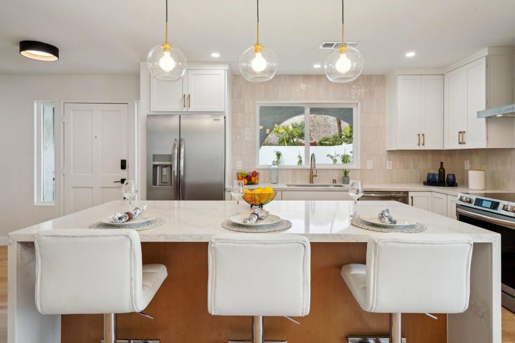 Seller Offering a 2-1 Mortgage Rate Buydown for Primary Residence Buyers.Take advantage of significantly reduced monthly payments for the first two years--making this stunning, remodeled home even more affordable.Located in a prime setting with panoramic mountain views, this beautifully updated home offers modern design and comfortable living. Step inside to an open-concept layout with clean lines and stylish finishes throughout.The chef's kitchen is a true showstopper, featuring a quartz waterfall island, custom cabinetry, pendant lighting, a built-in spice drawer, microwave drawer, and a pantry wired for a coffee bar--perfect for both everyday living and entertaining. Modern appliances complete this dream kitchen.The spacious living area includes a striking slat oak wood-faced electric fireplace, ideal for relaxing or hosting guests. White oak luxury vinyl flooring, 5-inch baseboards, and fresh interior and exterior paint provide a sleek, contemporary feel throughout the home.Generously sized bedrooms include a guest suite with an oversized walk-in closet. The bathrooms feature quartz countertops and spa-like touches that create a serene retreat.Step outside to your backyard oasis--perfect for relaxing by the pool or enjoying a quiet afternoon beverage.With the seller incentive, now is the perfect time to make this dream home yours!