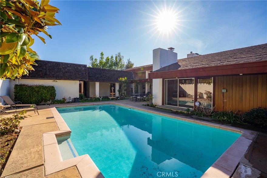 Now available again and priced reduced for immediate booking! Awe-inspiring, panoramic Coastline, Catalina Island, and City light views from this gated Mid-Century Modern home. Featuring a Private Interior courtyard patio with a huge (in-ground) pool surrounded by lush landscaping and a serene fountain. The open floor plan has walls of windows to the expansive ocean views, and a wrap-around patio/deck to lounge or dine alfresco.  Living Room has high-beamed ceilings, a large fireplace, and multiple seating areas from which you can enjoy sunrises over the sweeping Coastline to the south, and golden sunsets over Catalina Island to the north. Amazing. Remodeled kitchen and bathrooms, beautiful wood floors, and Spanish tiles throughout.  Most rooms feature floor-to-ceiling windows and glass doors that access the courtyard or 180-degree oceanview deck. Four spacious bedrooms (three with panoramic views, one with pool/patio view) and a den/family room with a fireplace (with a sofa that converts to a queen bed) offer ample space to enjoy the indoor/outdoor California lifestyle. Sleeping Accommodations for 10 people. The main floor primary bedroom suite has floor-to-ceiling windows overlooking Laguna Village, yet is completely private. The two bedrooms on the lower level are separated by the family room, all have ocean views. All rooms have sliders to allow in cool ocean breezes, and there is a Portable a/c unit for the few days a year it might be needed. Enjoy secluded sunbathing by the pool or wander down to Crescent Bay Beach and Village shops/restaurants - all just blocks away. Rates and terms are negotiable - available for long and short-term rentals (of 30+ days). Prices adjust according to term and season (long-term/off-season rates as posted, summer months are higher). Inquire.