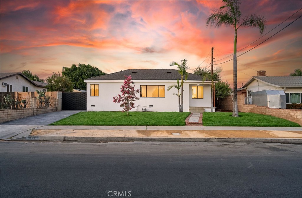 Beautifully upgraded 3-bedroom, 1-bath home blending charm and modern convenience. Recently renovated from top to bottom, this home features a brand-new roof, updated plumbing, fresh stucco, and a new concrete driveway. Step into a spacious living room with fresh paint and new oak flooring that flows seamlessly throughout. The dedicated dining area opens to a fully remodeled kitchen, complete with a new stove and microwave, sleek white cabinetry, and updated hardware. The bathroom has also been completely redone with modern finishes. A Bosch high-efficiency AC system and a tankless water heater add comfort and energy savings. The spacious indoor laundry room offers added convenience. Outside, fresh landscaping and elegant palm trees create inviting curb appeal, while the expansive backyard is perfect for entertaining. The detached garage offers excellent ADU potential.