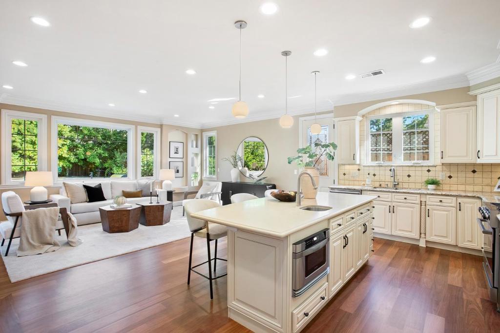Step into timeless charm with this 4BD/3BA Mediterranean-style home, built in 2011 with a thoughtful, flowing layout. Refinished hardwood floors, crown molding, central heat/AC, and a cozy fireplace offer warmth and elegance throughout. The living room features soaring ceilings and a fireplace, perfect for relaxing or hosting. The chef's kitchen boasts granite counters, a quartz island, ample cabinetry, and premium appliances, including a Viking fridge, gas range, and brand new dishwasher. The sunlit family room opens through French doors to a lush backyard serene retreat or entertainer's dream. A main-floor bedroom with a walk-in closet and full bath is ideal for guests or in-laws. Upstairs, the tranquil primary suite includes an en suite bath, while two additional bedrooms share a full bath. Outside, enjoy a private backyard with mature fruit trees, raised garden beds, built-in BBQ, landscape lighting, and a semi-enclosed patio for year-round use. The front yard is equally well-landscaped and welcoming. Additional features: washer/dryer, a second fridge in the garage, 1-car garage + 2 driveway spots. Located near top-rated JLS Middle & Gunn High, Stanford, Caltrain, California Ave, and two nearby parks. A home of comfort, beauty, and convenience ready for your next chapter.