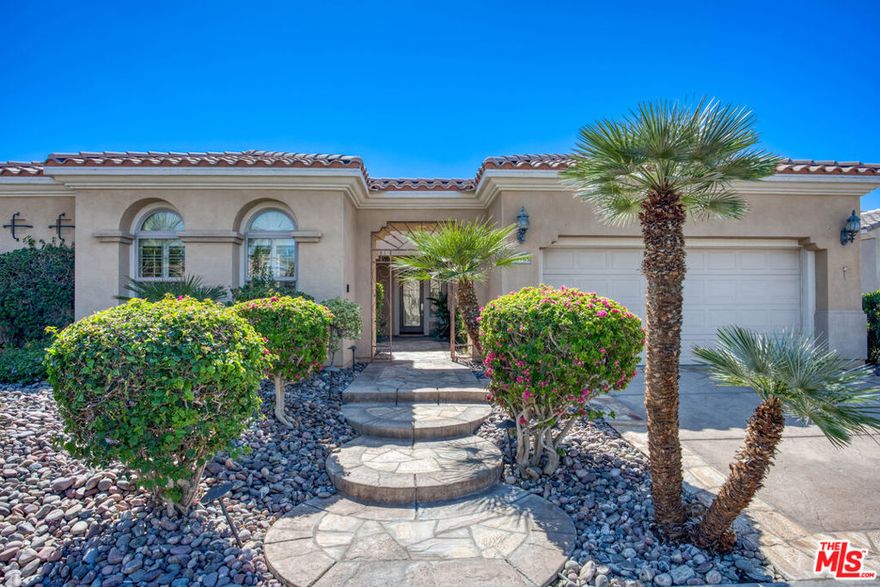 Rare and refined, this spacious residence in Del Webb's Sun City Indio  offers resort-style living with a stunning pool and mature landscaping including fruit trees that line the grounds with color and charm. There are 3 bedrooms + a den that can be converted to a 4th bedroom. An entertainer's dream, the home features a chef's kitchen with an oversized double oven, Bosch dishwasher, granite countertops, and a generous center island. The layout flows seamlessly from indoor spaces to the outdoors, where custom-carved stonework and a striking fireplace add warmth and elegance. A tiled, gated courtyard introduces the home and leads to a private casita complete with an en-suite bath and large closet perfect for use as a guest suite, home office, or studio. Inside, the primary suite impresses with an expansive bath, high ceilings, and wide plantation shutters throughout the home. Outdoors, the resort-style pool with waterfall and spa is joined by a gourmet kitchen equipped with an Alfresco grill, gas burners, sink, refrigerator, and a circular serving bar ideal for gatherings. A custom mechanical awning, fire pit, and multiple lounge areas complete this oasis. Designed by celebrity designer Mark Williams, the home may be sold fully furnished and appointed. Every detail reflects quality and comfort in this tranquil retreat for the discerning buyer. Located within the gated, 55+ community of Sun City Indio residents enjoy access to two clubhouses, fitness centers, two golf courses, and beautifully maintained groundsall for a low HOA fee of $369. *Furniture and Golf Cart optional.