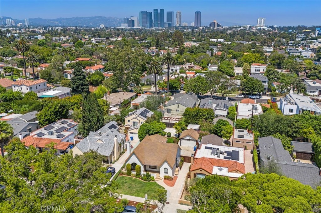 Nestled on one of West L.A.’s most picturesque, tree-lined streets, 2340 Camden Ave. offers the perfect blend of classic charm and everyday convenience. Located just minutes from UCLA Medical Center and within a short distance to the vibrant shops and eateries along Pico Blvd, this home places the very best of the Westside right at your doorstep.
Originally built in 1930, this timeless gem exudes warmth and architectural character throughout. From the charming covered front porch to the graceful archways and rich original details, the home tells a story of Los Angeles history, preserved beautifully and thoughtfully refreshed.
Inside, you’ll be greeted by soaring barrel-vaulted ceilings, arched transitions, and an impressive stone fireplace that anchors the sunlit living room. Oversized picture windows frame lush street views and flood the space with natural light, while original hardwood floors and a dramatic curved wood accent wall add texture, elegance, and a nod to mid-century design.
The residence features three generously sized bedrooms, including a spacious primary suite with its own en suite bathroom and direct access to the backyard, perfect for indoor-outdoor California living.
Proudly situated on a 6,756 sq ft lot, the home includes a detached two-car garage, a large grassy yard surrounded by mature trees, and a versatile bonus room/studio—ideal for a home office, fitness space, creative studio, or guest retreat. As an added bonus, a large, walkable attic provides excellent additional storage space with room to stand and move comfortably, an uncommon and practical feature for homes of this era.
Perfectly situated between Westwood and Century City, this is a rare opportunity to own a home full of soul, story, and sunshine in one of West L.A.’s most desirable pockets.