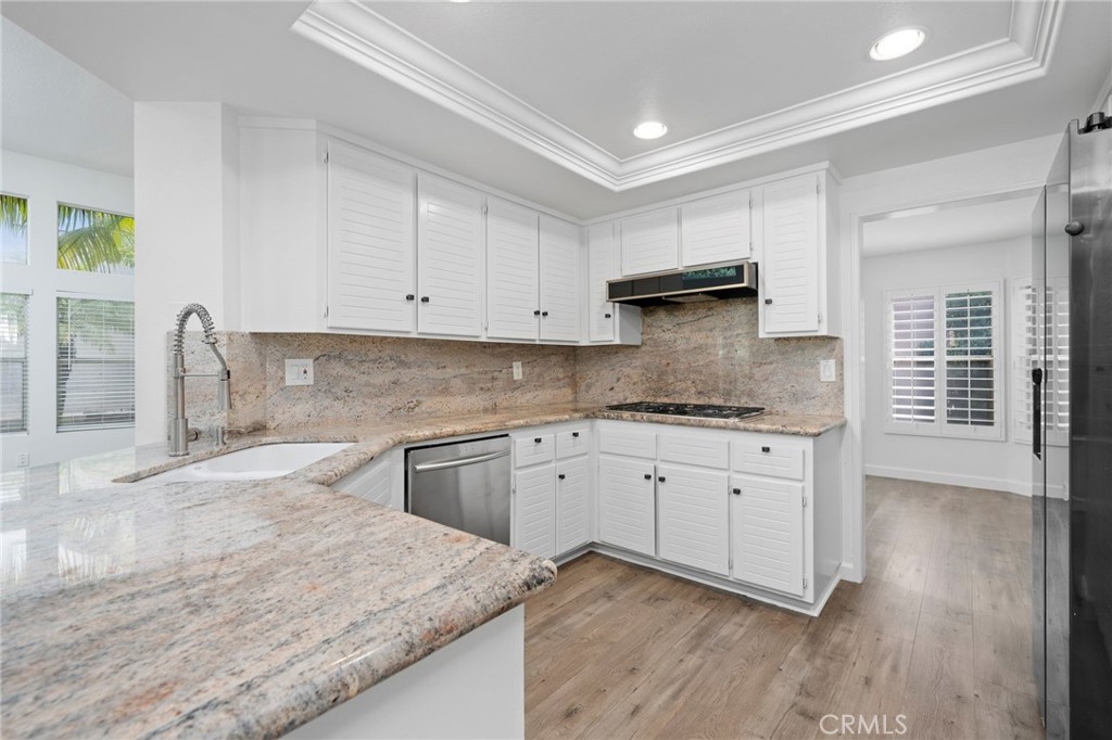 Welcome to your private oasis in the heart of Irvine’s coveted Westpark community. This inviting home offers a lush, green entry that opens to a spacious living room with soaring ceilings and a cozy fireplace. Thoughtfully designed for comfort and functionality, the main floor includes a bedroom with a full bathroom—perfect for guests or multi-generational living. The open-concept layout connects the laminate-floored living and dining areas to the kitchen, which boasts recently upgraded granite countertops and overlooks the backyard. Large windows flood the space with natural light and offer beautiful views of the pool and greenery beyond. Upstairs, you’ll find the expansive primary suite along with two additional bedrooms. The real gem, however, is the backyard—a rare find in Irvine. Generously sized and filled with mature landscaping, it features a sparkling pool, spa, and plenty of room for kids to play or for entertaining under the sun. Additional highlights include a two-car attached garage and an unbeatable location just minutes from top shopping, dining, and entertainment destinations like Irvine Spectrum Center, The Great Park, and UC Irvine. With convenient access to major freeways and John Wayne Airport, this home truly has it all.