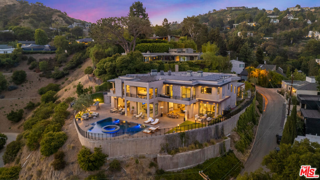 Fully furnished and equipped, this estate is available for long and short-term rentals. Experience unmatched elegance and privacy in this extraordinary estate nestled in the heart of the Hollywood Hills. Spanning over 9,300 sq. ft. of sophisticated living space, this home blends modern luxury with timeless design. Soaring vaulted ceilings and seamless home automation set the tone for refined living, while built-in automatic shades and an elevator provide ultimate comfort across all three levels. Relax and recharge in the wellness retreat featuring a dry sauna, steam room, and state-of-the-art infrared sauna. For entertainment, enjoy the full-scale, true movie theater experience designed to rival any cinema. Step outside to your private outdoor oasis, complete with a full bathroom, shower, and built-in BBQ ideal for hosting and entertaining under the California sun.