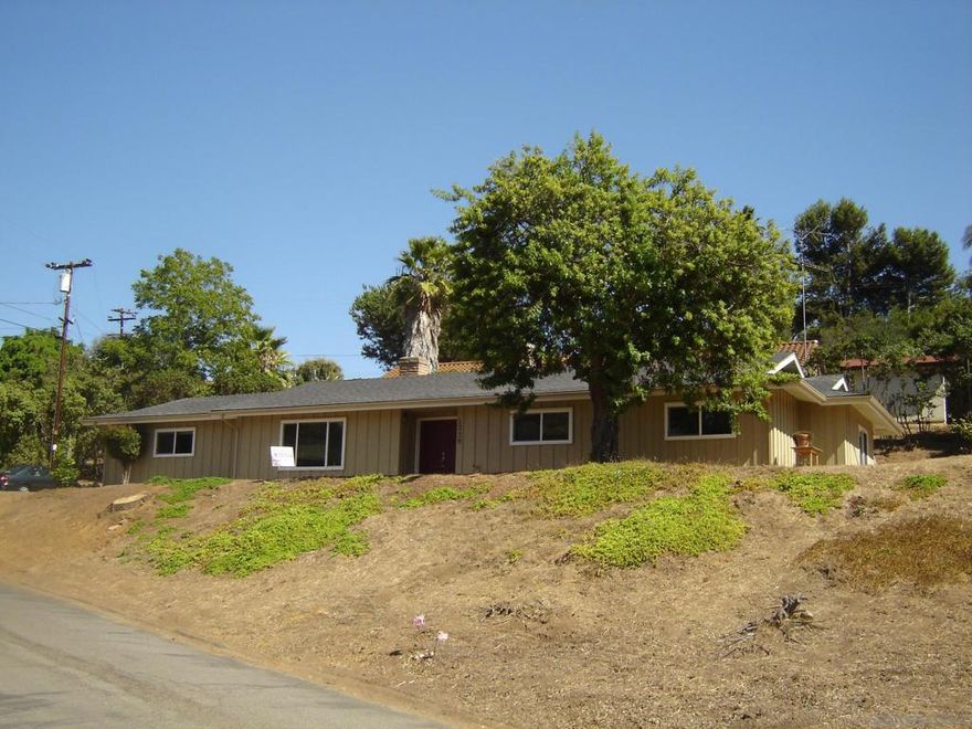 Nestled on a peaceful cul-de-sac, this charming single-story home sits proudly on a generous lot, offering stunning hillside views and plenty of usable outdoor space. Inside, you’ll find three spacious bedrooms and two well-appointed bathrooms, along with a comfortable family room, cozy living room featuring a warming fireplace, perfect for relaxing or entertaining. Also, enjoy a welcoming patio provides the ideal spot for outdoor dining and enjoying the view. The kitchen is equipped with an electric stove, double oven, dishwasher, and a large walk-in pantry for ample storage. Convenient indoor washer/dryer hookups in the attached 2- car garage. RV parking also available on the property.