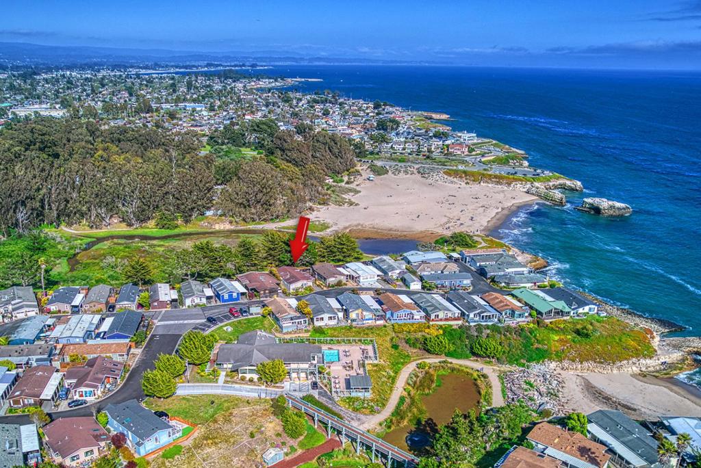 New price for this beautiful home with ocean/beach and greenbelt views, with lots of privacy! This home is situated on the Natural bridges State beach side of the park. The back deck offers ocean views, you can see the crashing waves, and occasionally see a deer walk behind State property, absolutely beautiful, and tranquil. When you enter this home you are welcomed with vaulted ceilings, a large living room, with a deck to sit and enjoy the ocean air, and ocean views, so tranquil! The large kitchen offers plenty of room for the cook, and room for friends/family. The nearby dining area is generous, and perfect to enjoy a meal, while enjoying the ocean nearby. Three generous side bedrooms offer extra room for guest, and office, hobby room, or whatever your needs are. There is a walk in closet in the primary bedroom also. The laundry has a washer/dryer, included in sale, and room to fold your clothes, and lots of storage also. This is a turnkey home, super clean, and ready to move into. Don't miss your chance!! Space rent $4168/month.