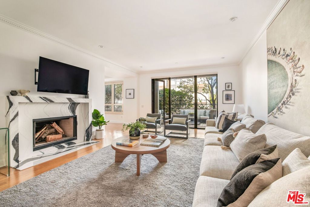 Set within the prestigious Brentwood Park Condominiums, this completely remodeled end-unit residence offers the ideal blend of modern design, ample natural light, and effortless single-level living in one of the Westside's most sought-after neighborhoods. From the formal entry, discover a bright and airy floorplan featuring warm wood floors and thoughtfully curated finishes throughout. The spacious living room opens to one of two private balconies and is anchored by a stone fireplace, while the window-lined formal dining room stuns with a trey ceiling and garden views. Just beyond, the gourmet kitchen is a culinary dream -- outfitted with striking stone countertops and premium Wolf & SubZero appliances, including a professional-grade range and built-in, temperature-controlled wine storage. A family room off the kitchen creates the ideal space to relax or entertain and a stylish powder bath adds convenience for guests. Two ensuite bedrooms provide serene retreats, including a luxe primary suite with a generous walk-in closet and a spa-quality bath with double vanities, a soaking tub, and a glass-enclosed tile shower. Residents of Brentwood Park Condominiums enjoy a concierge, controlled building access with security, secure garage parking with guest parking space, a well-appointed fitness center, HBO, and beautifully landscaped courtyards. All this, just moments from top-rated schools, Brentwood Country Club, the Farmers Market, Country Mart, and San Vicente's fine dining and boutiques. Modern luxury, timeless Brentwood charm -- this is elevated Westside living.