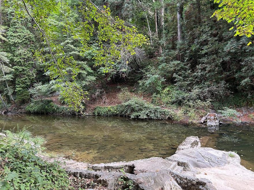 PRIVATE BEACH on the San Lorenzo River. Discover a rare gem in the heart of the Santa Cruz Mountains just one minute from Highway 9. This unique riverfront property offers private access to the San Lorenzo River, complete with a secluded beach that is also your very own fishing hole. There are stairs from the parking area down to the riverbank where serenity meets design potential. Whether you're a seasoned landscape architect or a visionary hobbyist, this site is a blank canvas for creating terraced gardens, meditation decks, or patios overlooking the water. There is off the road parking for two cars  and additional space for 4 vehicles at the adjacent turnout.