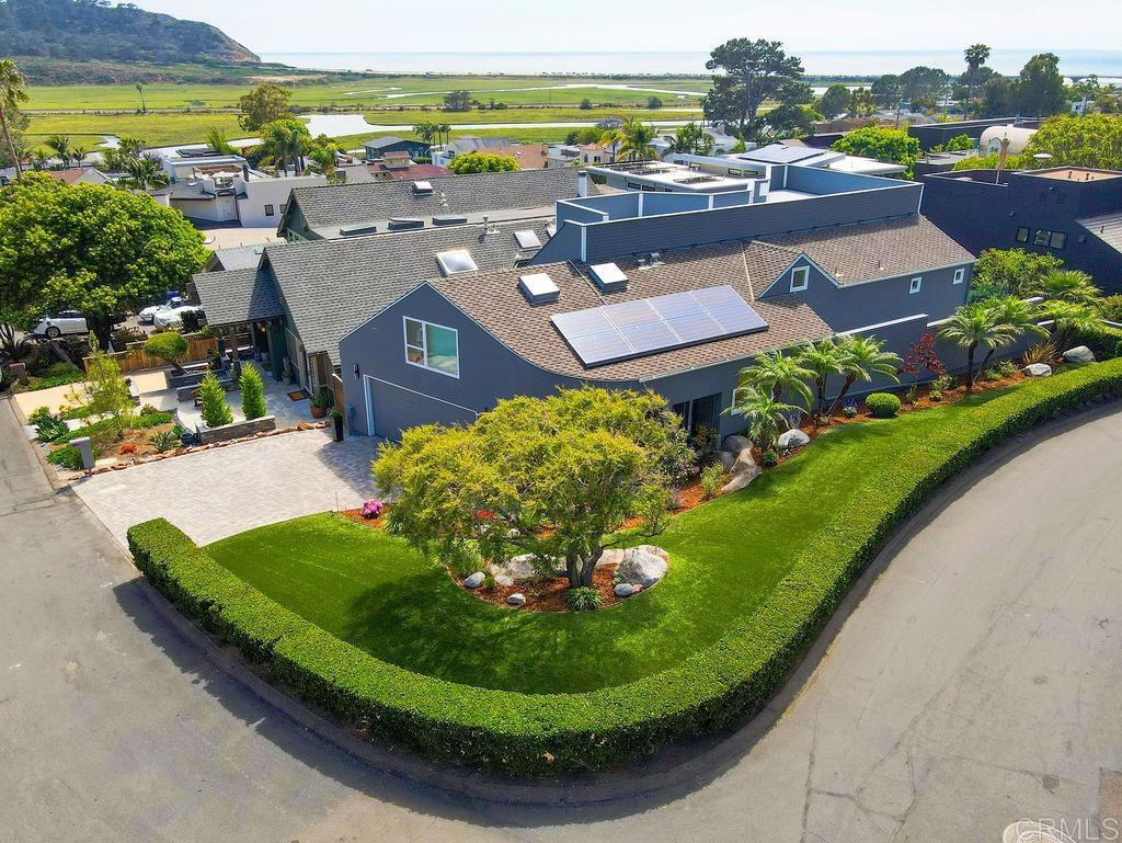 Welcome to coastal living at its finest. This beautifully remodeled Del Mar residence, updated between 2016 and 2023, offers over 3,000 square feet of thoughtfully designed living space with 3 spacious bedrooms plus a dedicated office. Located just a short stroll from Torrey Pines State Beach, this home seamlessly blends modern elegance with beachside tranquility. Enjoy breathtaking coastal views from the expansive rooftop deck, perfect for relaxing sunsets or entertaining guests. The stunning kitchen remodel features Miele appliances, a Sub-Zero refrigerator, custom-made cabinetry, and a striking quartz waterfall countertop. French oak wood floors flow throughout, adding warmth and sophistication. Additional upgrades include an owned solar system and a full house water filtration and conditioning system for ultimate comfort and efficiency. Experience the best of Southern California lifestyle in this move-in ready retreat, moments from Del Mar’s beaches, trails, and vibrant village.