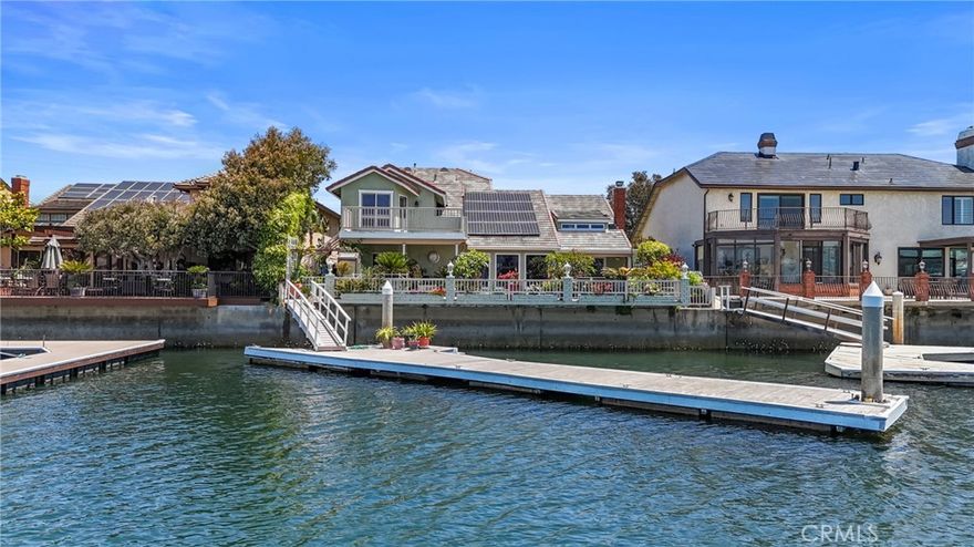 Prestigious Waterfront Estate on Trinidad Island in Huntington Harbour on the coveted main channel with private dock and spectacular, sweeping views  that are truly unmatched! Welcome to one of the most exclusive waterfront offerings in Huntington Beach. And yes, the Holiday Boat Parade starts right in front of this house. So, get ready to entertain and enjoy the waterfront lifestyle with a supersized "Dock for your Yacht" and a lifestyle you have only dreamed of and now it can become a reality. This home has never been on the market before and has one of the most sought after private waterfront locations with over 60 feet of private water frontage. No public access and no one elses slip or dock will be in front of this exclusive property unless you choose to rent the 2 slips out and enjoy the income from the HUGE dock with 2 slips. There are views from almost every room in the house. The main living space has easy access to a spacious harbour front terrace, covered patio with spectacular views, creating the perfect setting for everything from sunset soirées to quiet mornings with coffee by the water. Upstairs the primary suite is a private retreat, offering stunning habour views from a large balcony. Watch the boats glide by from your amazing views from the kitchen window. There is a separate formal dining room, formal living room, family room with cozy fireplace. Upstairs there is potentially 4 bedrooms but currently the defined space is 3 bedrooms and a huge office which is perfect if you get to work from home. The spa-inspired bathroom features luxurious finishes, and the walk-in closet is spacious enough to satisfy any wardrobe. There is a laundry room upstairs and one downstairs. BONUS*solar is paid. Price per square foot does not factor in the value of the dual sided dock which is a huge added value and that can be provided upon request.  This is a rare opportunity to live the iconic Huntington Harbour Yacht Lifestyle in a truly one-of-a-kind location on the main channel in Huntington Harbour with a dock just waiting for your yacht.  This uniquely angled dock can accomodate a 70'+ on one slip and a 50'+ on the other slip. Embrace the very best of coastal California living in the SURF Capital, Huntington Beach. You are close to all your favorite destinations, shopping, restaurants, beaches, yacht clubs and mintues from the John Wayne Airport. Come live the dream.