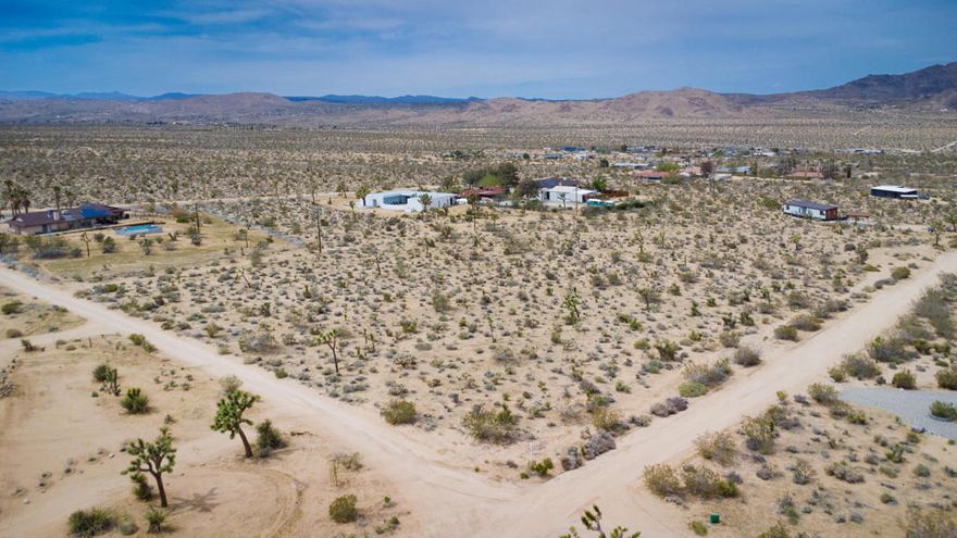 Unbeatable Location Near the Village & National ParkSeize this rare opportunity to own a 1.25-acre parcel in one of Joshua Tree's most desirable areas! Perfectly situated just minutes from the vibrant Joshua Tree Village and the entrance to Joshua Tree National Park, this lot offers the ideal setting for a stunning desert retreat or investment property.Surrounded by new high-end developments, this property boasts proximity to paved roads and essential utilities, making it an excellent choice for developers, investors, or anyone looking to build their dream home in a prime location. The expansive lot provides breathtaking panoramic views of the desert landscape, creating an unparalleled sense of peace and privacy while remaining conveniently close to shopping, dining, and entertainment.