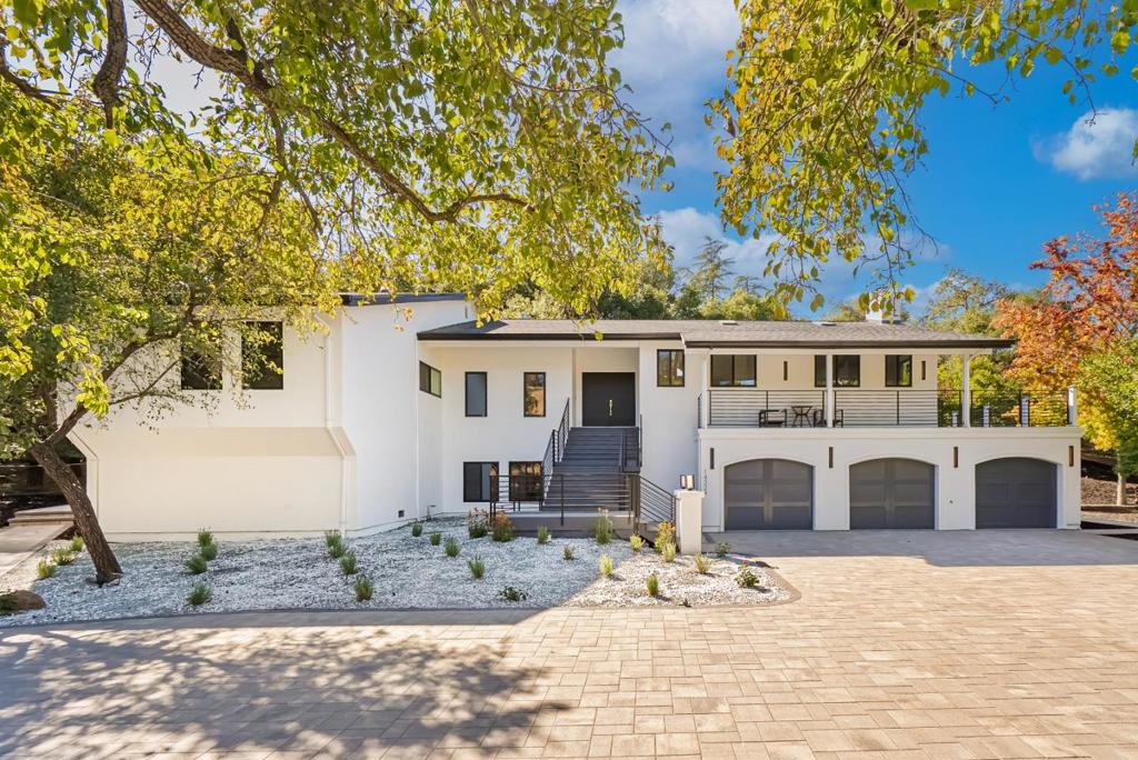 Located on a quiet private road cul-de-sac, this completely remodeled luxury home offers 4,861 sqft of luxurious living space on a 1+ acre park-like lot. The main level (over 3,000 sqft) features 4 bedrooms and 3.5 baths, including 2 master bedrooms and a bright open floor plan with a high-ceiling great room and formal dining area. The lower level offers 2 additional spacious master bedrooms, a living area, and a den/flex room perfect for guests & multi-generational living. Enjoy European oak engineered wood floors, custom natural wood kitchen cabinetry, marble waterfall island, and Bosch stainless steel appliances. All bathrooms are spa-inspired, finished with Porcelanosa premium tiles and designer fixtures. The property features a 3-car garage and a bonus 700 sqft basement (not included in the sqft), easily convertible into a home theater. Outdoors, enjoy the circular driveway with new pavers, low-maintenance turf, yard lighting, fire pit, newly landscaped front, side, and backyard, deck, waterfall feature, jacuzzi, and multi-level terraces creating your own private hiking park. This is a rare opportunity to own a spacious, modern, and tranquil estate in one of Saratoga's most sought-after neighborhoods offering the perfect blend of luxury, privacy, and resort-style living.