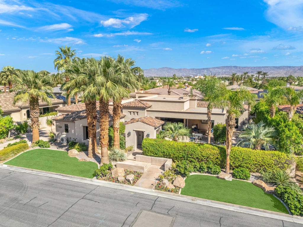 Built by renowned Ministrelli this outstanding home is one of the finest and best locations at Indian Wells Country Club within the prestigious Villaggio community. Light and bright California open floorplan and Tuscany design is quality built from start to finish! Spectacular Mountain Views directly south facing with walls of glass which disappear and open to large 422 Square Foot covered loggia with fireplace, beautiful pool and raised spa, and outdoor barbeque island. Fabulous Views and spacious indoor/outdoor living, this private home features 4632 Sq. Ft. of indoor living, 4 spacious Bedrooms with ensuite baths, 4.5 Baths, Great Room with fireplace, Formal Dining Room has adjoining impressive Wine room. Open Gourmet Kitchen boasts 2 islands with bar seating, 2 stainless steel sinks, Wolf appliances, and gorgeous granite countertops. Primary bedroom has fabulous pool and mountain views with French doors to direct access to loggia, pool/spa. Grand Primary Bath features dual sinks plus vanity, jet tub spa, and huge walk-in closet. Interior Design features include extensive use of granite and marble, faux and stenciled wall paint, art niches, built-in wood cabinetry, carpeted bedrooms, and gorgeous Versailles pattern travertine floors. Total of 3 car garages, with epoxy flooring and built-ins for extra storage. Elegance, Style, and Luxury!