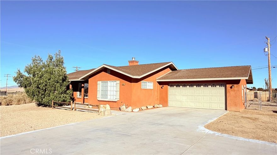 One of the best move in ready homes you’ll find at this price point—clean, well-maintained, packed with nice features and located just minutes from the entrance to Joshua Tree National Park. Inside, you’ll find tile flooring throughout, forced-air A/C, propane heat, and an additional mini-split unit in the living area for extra comfort. The living room features high ceilings, plenty of natural light, and a fireplace. The primary bedroom is a standout, offering two walk-in closets, separate linen storage, dual sinks, and a private bath area with tub, shower, and toilet. The split-bedroom floor plan gives everyone extra privacy. The kitchen offers plenty of storage, tile countertops, a pantry, and newer appliances, including the refrigerator. Off the kitchen is the dining area with slider to the ample backyard that extends beyond the chain link fencing. Every room comes with ceiling fans to keep things comfortable too. Enjoy the convenience of a separate laundry room with a washer and dryer included. Outside, the property features a front porch, concrete driveway with a turnout, and freshly painted fascia.
