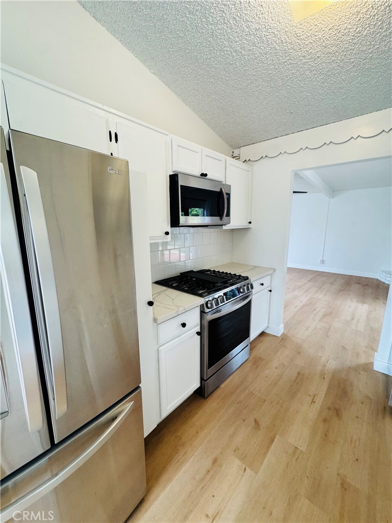 Great 3 Bedroom and 2 bath newly remodeled on a cul-de-sac. New driveway leading to front doors opening up to a modern concrete design wall. Walk to the right side you have a sitting area and dining room with modern chandelier. Then walk into the kitchen nook with view of front yard. The Kitchen has brand new LG Refrigerator with water dispenser and ice maker inside. The LG stove is gas with a convection oven. New dishwasher and microwave. The counters have marble tops and tile with 2 shelves great for plates or coffee mugs. Then walk into the Living room light and bright. Patio is accessed thur both the Living room and the Dining room and sitting areas. The 3 bedrooms all have ceiling fans with lights and drapes thru out. Two of the bedrooms feature build in book or display shelving with storage below. The master has a en suite with a shower. The hallway bathroom has a tub shower combo and modern tile on the walls. New roof, water heater, electrical panels, and sitting on a 7,000 sq ft lot. Washer and Dryer are in the attached garage. The home has 3 wall unit AC units and a furnace to heat the home. Laminate flooring throughout the house.