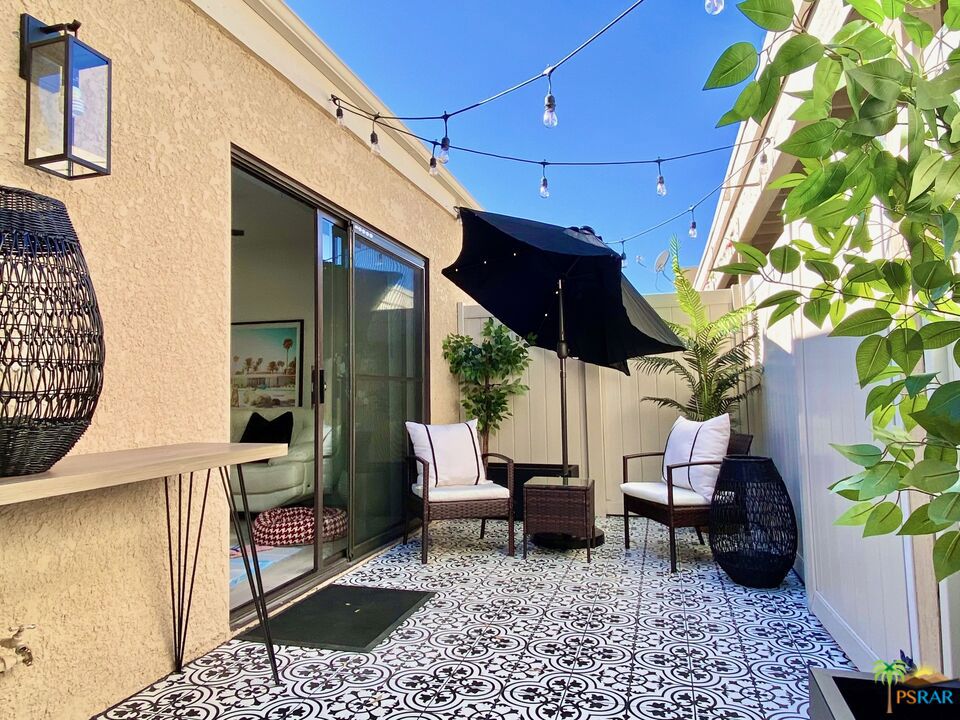 Owner purchased the land so you own the land on this unit. This 2 bedroom 2 bath condo has been meticulously renovated and professionally designed with all the WOW factors. Stylishly furnished and stocked will all the essentials for modern living. There are 2 bedrooms (1 king bed, 2 single beds). Each has its own closet and Smart TV . The living space is extended by a picture perfect private patio. Some furnishings available outside of escrow. All windows have custom motorized window treatments. Multiple pools, spas and tennis courts and clubhouse in the complex! Centrally located 10 min away from Palm Springs.