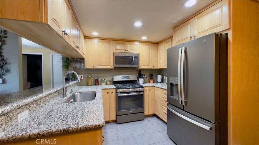 Welcome to this charming first-level condominium located in the heart of San Fernando. Set within a secure, gated community, this 2-bedroom, 2-bathroom home offers comfort, convenience, and style.

Step into a recently remodeled kitchen that’s truly a must-see—featuring custom maple cabinetry, stunning granite countertops, soft-close drawers, recessed lighting, durable tile flooring, and GE slate fingerprint-resistant appliances. Additional cabinets providing extra storage space, perfect for keeping everything organized.

The open-concept living room flows seamlessly into a small private patio, ideal for relaxing or entertaining. Living room and hallway have brand new waterproof flooring, bathroom has been tastefully updated with modern finishes to create a spa-like atmosphere.

The spacious primary bedroom includes a walk-in closet and direct access to a second small patio. Recently painted throughout the property. Other highlights include tandem two-car covered parking, a community pool and hot tub, community laundry facilities, and a recreation room.

Situated just minutes from freeways, public transportation, and local shops, this home offers both convenience and a wonderful lifestyle. Don’t miss out!