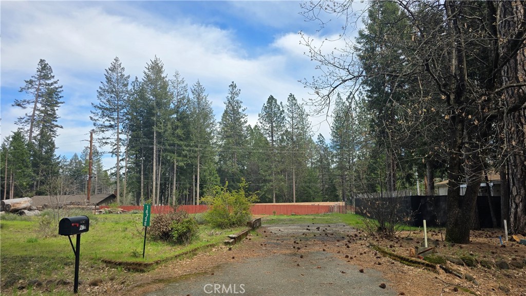 WONDERFUL OPPORTUNITY FOR LOT WITH NO HOMEOWNERS ASSOCIATION! This lot previously had a 2-bedroom, 2-bath home that was 1464 sq.ft. and those impact fees have already been paid, so this will save money on the new permit costs. All utilities are available on the property as well as an existing septic system that was working at the time of the fire but has not been inspected since. This property was lost in the 2018 Camp Fire and is on the edge of the effected fire area. It sits in a neighborhood that was almost untouched and is still surrounded by beautiful tall trees and a forested setting. Only a few miles to local shoppping, dining, post office & Magalia Community Park's social events and the Disc Golf Course, this is a great location. Whether you're looking for recreation, social events, or relaxation, this community has something for everyone. The neighborhood features plenty of open space and mature trees, creating a unique mountain retreat atmosphere. Outdoor enthusiasts will love the close proximity to biking, hiking, and fishing, as well as the endless water adventures at Paradise Lake, DeSabla Lake, Lake Oroville Marina, and the Feather River. With its fantastic community amenities, and prime location near nature and recreation, this home offers an incredible opportunity for first-time buyers, downsizers, or investors looking for a great property with development potential. Commuting to Paradise, Chico, and Oroville is also easy and stress-free, so get out of the busy city and valley heat and come build your new home on this beautiful lot!