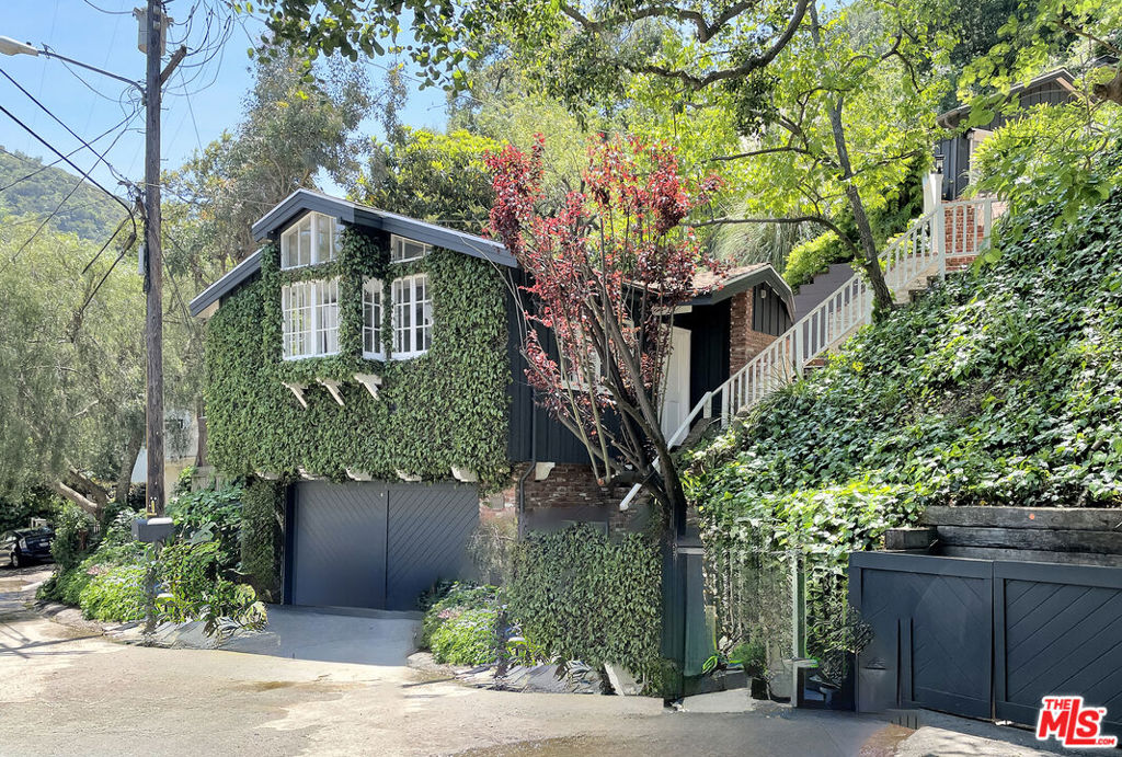 Charming ivy-covered studio guest house cottage in a serene setting off Benedict Canyon. This studio sits above the street over the garage, it is one large, light and bright open room, recently remodeled, has an updated bathroom and small kitchen. It has vaulted ceilings, windows overlooking trees and the surrounding canyon. There is a walk-in closet, newer kitchen appliances, has A/C and heat, and also has a separate private patio, easy street parking and laundry in the garage. Electricity, gas, water, gardener and WIFI are included. The peacefulness and calm of this special location will capture your senses. No sign on property. Please do not disturb occupant.