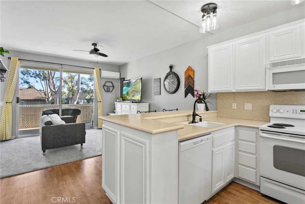 LOWEST-PRICED property in HB with private laundry! Charming studio condo located in a 24-hour guard-gated community less than a mile and a half from the beach. Open layout featuring a kitchen with sit-down bar, living area, full bathroom, sleeping area, dual closets, and spacious private balcony with storage closet. Additional features include modern lighting and fixtures, stackable washer/dryer (purchased in 2023), and a mini-split HVAC system (2021). Convenient elevator access from the subterranean parking area is ideal if you need to avoid stairs. Amenities offered within the community include pools & spas, fitness center, sauna, clubhouse, tennis courts, and greenbelt areas. HOA fee includes water, trash, exterior maintenance & insurance, as well as amenities. The roofs were replaced in 2024.