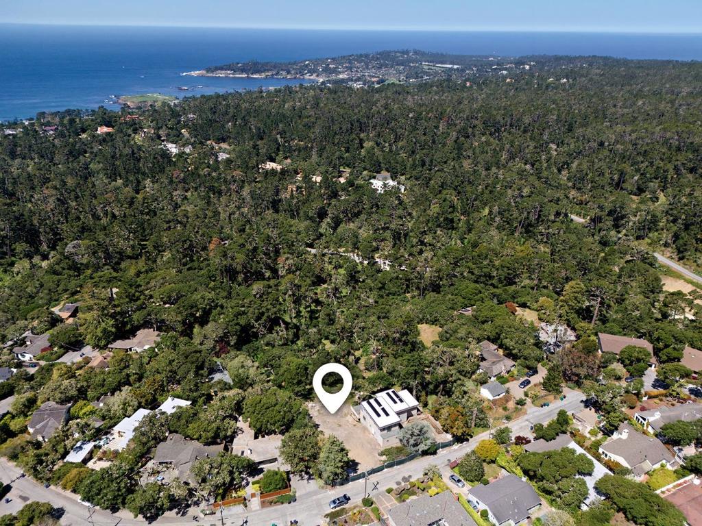 Permitted, ready to build lot nestled into the natural topography of the peaceful Carmel Woods neighborhood. This gently sloped 9,975 SqFt lot offers a clear, buildable area with enhanced privacy. At the rear, it borders a permanent greenbelt owned by the Pebble Beach Company, ensuring a serene, undeveloped backdrop. With water already on-site, a straightforward gas connection across the street, and PG&E upgrades in process, including a new pole and transformer, the remaining utility coordination is expected to align with a standard construction timeline. Included county permitted plans feature a thoughtfully designed home with classic Spanish architectural elements. The layout, ideal for multigenerational living, includes an expansive daylight basement, with provisions for an elevator and solar panels to provide both accessibility and energy efficiency. This is a rare opportunity to build in Carmel, just up the street from downtown's incredible restaurants, shops, and beaches.