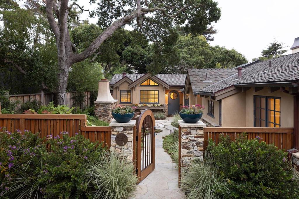 Half Pint is a dream cottage in the golden rectangle of Carmel-by-the-Sea. Reimagined down to the studs about five years ago, this single level home was rebuilt to the highest standards of craftsmanship and professional design. Behind the front gate, the warm stucco and masonry exterior perfectly complements the verdant garden and Carmel stone outdoor fireplace. This three bedroom, two bathroom single level residence enjoys high vaulted ceilings, exposed beams, and custom finishes throughout including leathered marble counters, wire brushed reclaimed-oak floors, African mahogany doors, natural clay walls, and more. All major systems have been upgraded including new electrical, plumbing, radiant heat, and roof with skylights offering wonderful natural light. The backyard is a private spa oasis, beautifully centered around a vibrant Japanese Maple set within tall ivy-rich fences. Every detail was accounted for on this quintessential Carmel home just four blocks to the beach, and six blocks to town.