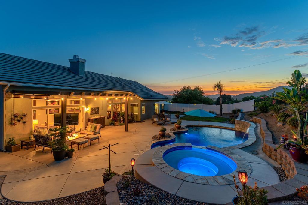 Nestled on a generous 1.29 acre corner lot with sweeping mountain vistas, this modern four bedroom, three bath estate spans 2,862 square feet of refined living. From the moment you enter, you feel the intentional design, light dances across beautiful new floors, while thoughtfully reglazed windows frame vivid sunsets that seem to linger a little longer here. Clean energy flows from the solar system, powering a home as forward-thinking as it is serene. The saltwater pool, encircled by natural stone coping and shimmering with PebbleTec brilliance, invites you to unwind under an aluminum steel patio cover, installed in 2021 for year-round outdoor comfort. Indoors, every element speaks of detail and care from bronze finished interior hardware to custom shutters and updated baths boasting double vanities, radiant floors, and a soaking tub that turns bathing into ritual. Each bathroom has been fully reimagined with premium materials, blending spa-like elegance with smart functionality. Comfort is redefined with a dual zone Lennox HVAC system (2023), upgraded attic insulation, solar radiant barriers, and wireless-controlled Quiet Cool ventilation systems. Each bedroom offers filtered airflow, privacy, and calm. Tech savvy living extends to the WiFi enabled Pentair pool system. Ample space on the lot across Twin Peaks Pl offers future potential for an ADU. This is more than a home, it’s a feeling. A sanctuary where every day closes with golden light and silence settles like luxury itself.