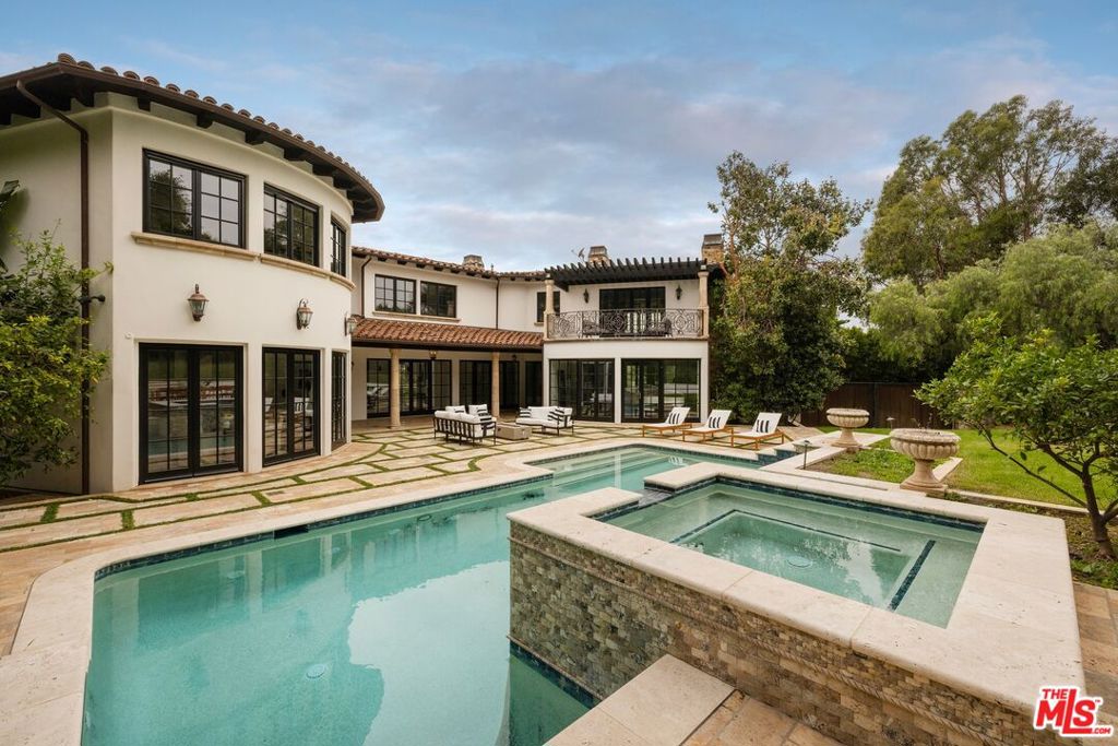 Adjacent to Brentwood Park this gated Mediterranean is timeless and elegant. Enter a grand foyer with soaring ceilings, natural light with a feeling of elevated sophistication in its design. Amenities, include a gourmet kitchen, newer appliances, a wine cellar with a tasting room, theater, pantry, cozy office, elevator to all 3 floors, staff area with dumb waiter. Main level has a formal living + family room, dining room, multiple fireplaces with triple glazed windows imported from Germany. Retreat to a large master suite, a sanctuary of indulgence, complete with a private balcony, fireplace, spa-like ensuite bath, unique oversized steam shower room and expansive walk-in closets. 4 additional en-suite bedrooms provide great comfort and privacy for family and guests. Designed for the ultimate R&R and entertainment the lower level has cool area with a bar plus a large theatre and potential gaming room. The outside has a luxurious pool and spa, creating an idyllic setting for year-round enjoyment. Conveniently located near the great dining, shopping, and entertainment destinations that Brentwood has to offer, this outstanding property represents a beautiful home of West Coastal luxury living. The adjoining lot at 13043 Sunset Blvd standing at 21,939 Square feet is also available for $2,900,000 which would bring this estate to almost an acre.