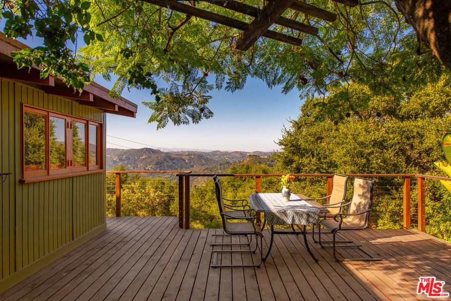 Endless Views & Soulful Vibes.   Set on a sun-drenched half-acre in the heart of Topanga, this enchanting 2-bedroom, 2-bath sanctuary offers panoramic canyon views and a seamless blend of creativity, comfort, and connection to nature. Brimming with quintessential Topanga charm and brimming with potential, this is more than a home, an invitation to live expansively and authentically. Step inside to an open-concept kitchen, living, and dining area where skylights and oversized windows flood the space with natural light, blurring the line between indoors and out. The layout flows effortlessly for entertaining or quiet evenings at home, while bohemian finishes and earthy textures infuse the space with warmth, artistry, and soul. This is a home that feels alive, with energy, character, and harmony. The primary suite is a calm retreat, featuring its own private deck, a custom closet, and direct access to a secluded hot tub, ideal for stargazing or early morning reflection. A second bedroom or flexible office space provides room to adapt to your lifestyle needs, and the detached guest house is a exceptional bonus that offers even more versatility, perfect for hosting visitors, creating a studio, or generating rental income. Outdoors, you'll find tucked-away sheds, spaces for gardening, and open sky stretching for miles. Whether you're envisioning using the sheds for your art studio or creating a compound of rich spices and herbs to grow, or simply a quiet haven to enjoy the ever-changing canyon light, the land welcomes your vision. Located just minutes from Topanga's village center, scenic hiking trails, Malibu's beaches, Santa Monica's energy, and the San Fernando Valley, this is a place where you can live, love, and grow into the next version of yourself