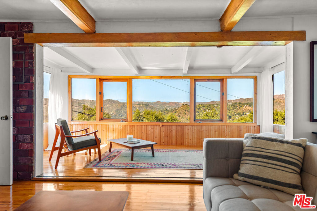 Endless Views & Soulful Vibes. Set on a sun-drenched half-acre in the heart of Topanga, this enchanting 2-bedroom, 2-bath sanctuary offers panoramic canyon views and a seamless blend of creativity, comfort, and connection to nature. Brimming with quintessential Topanga charm and brimming with potential, this is more than a home, an invitation to live expansively and authentically. Step inside to an open-concept kitchen, living, and dining area where skylights and oversized windows flood the space with natural light, blurring the line between indoors and out. The layout flows effortlessly for entertaining or quiet evenings at home, while bohemian finishes and earthy textures infuse the space with warmth, artistry, and soul. This is a home that feels alive, with energy, character, and harmony. The primary suite is a calm retreat, featuring its own private deck, a custom closet, and direct access to a secluded hot tub, ideal for stargazing or early morning reflection. A second bedroom or flexible office space provides room to adapt to your lifestyle needs, and the detached guest house is a exceptional bonus that offers even more versatility, perfect for hosting visitors, creating a studio, or generating rental income. Outdoors, you'll find tucked-away sheds, spaces for gardening, and open sky stretching for miles. Whether you're envisioning using the sheds for your art studio or creating a compound of rich spices and herbs to grow, or simply a quiet haven to enjoy the ever-changing canyon light, the land welcomes your vision. Located just minutes from Topanga's village center, scenic hiking trails, Malibu's beaches, Santa Monica's energy, and the San Fernando Valley, this is a place where you can live, love, and grow into the next version of yourself