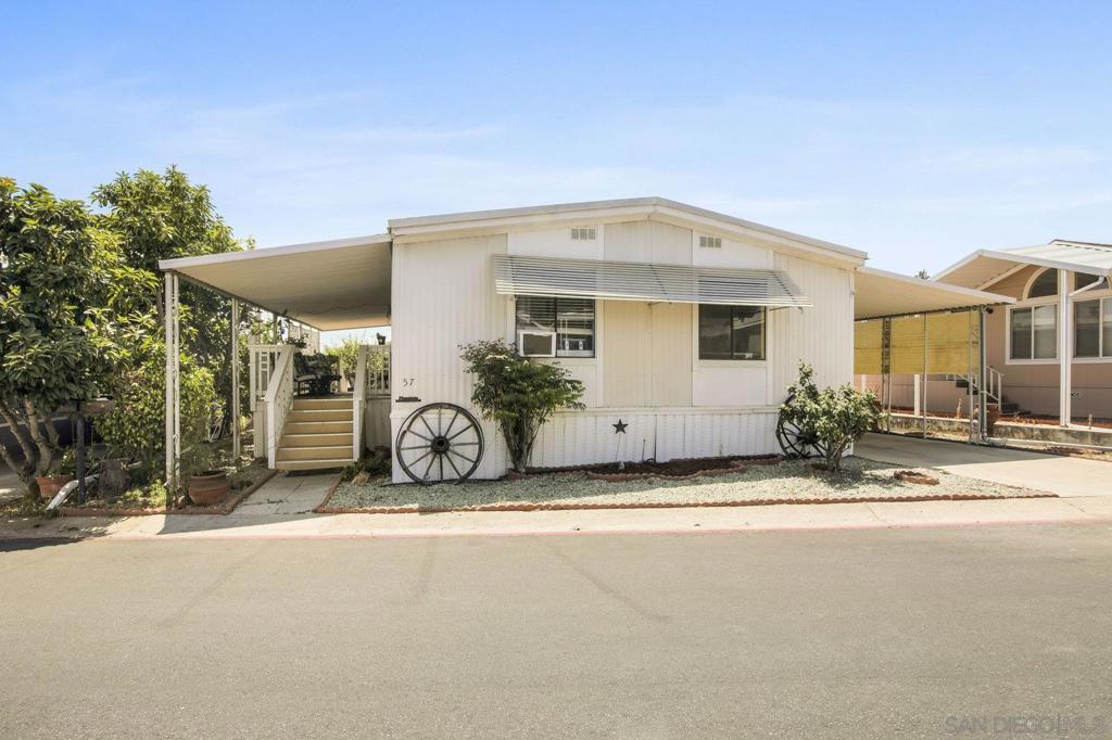 Welcome to Singing Hills Mobile Estates! Nestled in the highly desirable, all-ages community of Rancho San Diego—right across from Valhalla High School—this beautiful manufactured home offers comfort, space, and convenience. Featuring 3 spacious bedrooms and 2 full bathrooms, the home welcomes you with an open-concept layout connecting the living room, dining area, and kitchen—perfect for entertaining or relaxing with family. The primary suite is thoughtfully positioned for added privacy, separated from the other two bedrooms, and includes its own full bathroom.