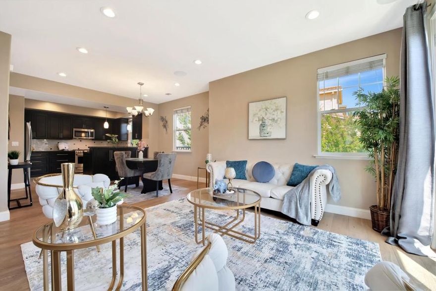 Welcome to this beautiful 4-bedroom, 4-bath corner home located in the desirable Communications Hill community. With three private suites plus an additional bedroom, this home offers flexible space ideal for multigenerational living, guests, or a home office. The open-concept main level features a bright living area, dining space, and a spacious kitchen with granite countertops, quartz tile backsplash, tile flooring, stainless steel appliances, and cabinetry with roll-out shelves. White Oak hardwood floors flow through the living area, and recessed speakers add to the entertainment experience. A private balcony offers a quiet space to enjoy fresh air or morning coffee. Upstairs, the grand primary suite features plush carpet, a ceiling fan, a walk-in closet with a custom organizer, and an ensuite bath with dual sinks, extra cabinetry, and tile flooring. Additional highlights include multi-zone heating and A/C, a second-floor laundry area, and an oversized two-car garage with a workbench and built-in organization. Ideally located near parks, shopping, and commuter routes, this home offers comfort, functionality, and style in one of San Jose's most sought-after neighborhoods.