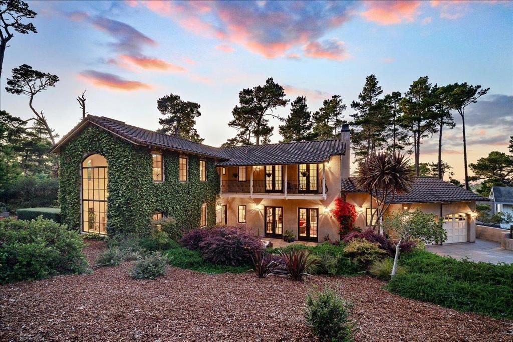 Tucked behind a private gate, nestled on an oversized 1/3 acre lot, this exquisite Spanish Mediterranean retreat offers timeless design, refined craftsmanship and unmatched privacy. This spacious home is surrounded by a meticulously landscaped yard with scenic patios, balconies and a hot tub over looking the peaceful garden making it ideal for relaxing or entertaining in elegance and comfort. The property sits adjacent to several hundred acres of forested preserve with walking and riding trails offering the best of outdoor opportunities. This home features 4 spacious bedrooms and 3.5 bathrooms, including two elegant primary suites, one on the main level, both with spa inspired bathrooms and private outdoor access. Special perks such as a whole house generator, car lift and safe pet in and out access enhance the livability. Ocean peeks are visible throughout the home, where large windows and graceful balconies welcome natural light and coastal breezes. Located moments from Monterey Peninsula Country Club, world-class golf and the scenic 17 Mile Drive as well as shopping, this property offers both seclusion and convenience in the heart of Pebble Beach.