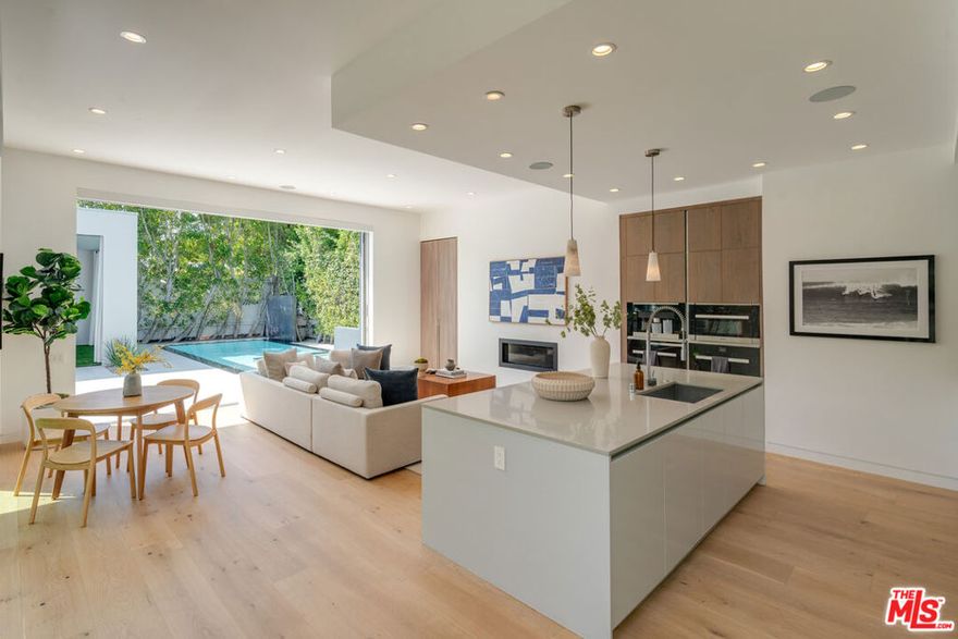 Welcome to 419 Westbourne Dr, a luxurious Organic Modern retreat nestled on a serene Cul De Sac street adjacent to Beverly Hills. This sprawling estate boasts one of the best lots and house in the area, offering unparalleled privacy and space. Impeccably designed with 11-foot ceilings throughout, this home features motorized shades in the living area and Fleetwood Pocket doors throughout, seamlessly blending indoor and outdoor living. Entertain guests with ease in the outdoor cabana, complete with a movie projector. Enjoy modern conveniences with a fully equipped alarm system, high-speed WiFi, and Crestron Smart Home System. Indulge in culinary delights with Miele appliances and a morning bar featuring a Miele Coffee machine in the primary bedroom. Relax in style with a Toto smart toilet in the primary bedroom and window window coverings throughout for added tranquility. Outdoor amenities include a BBQ area, zero-edge saltwater pool and spa, and a spacious grass area for both entertainment and children's enjoyment. Additional features include Electric Car Charging, French white oak wood flooring and security cameras throughout. Experience the epitome of luxury living in this exquisite West Hollywood oasis.