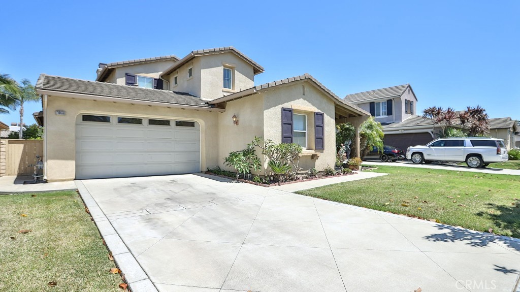 This stunning 4-bedroom, 3-bath residence offers a lifestyle you've always dreamed of. The main level flows effortlessly with a beautiful mix of hardwood and elegant tile floors, leading you through a spacious kitchen home designed for both grand entertaining and cozy family moments. Multiple living spaces, including a formal dining room, a welcoming living room, and a spacious family room. A rare and invaluable feature is the convenient downstairs bedroom and a bath, perfect for a home office, a comfortable guest suite. Upstairs, a serene retreat awaits with three additional bedrooms with a Master bedroom and the additional practicality of a Jack and Jill bathroom. The open-hallway design creates a sense of space and light, making the home feel even more expansive. Gather with friends around the inviting fire pit on the backyard or on the side addition beautiful patio on cool evenings, or stroll through your private grove of fruit trees—a truly unique and bountiful feature. Schedule your tour today!