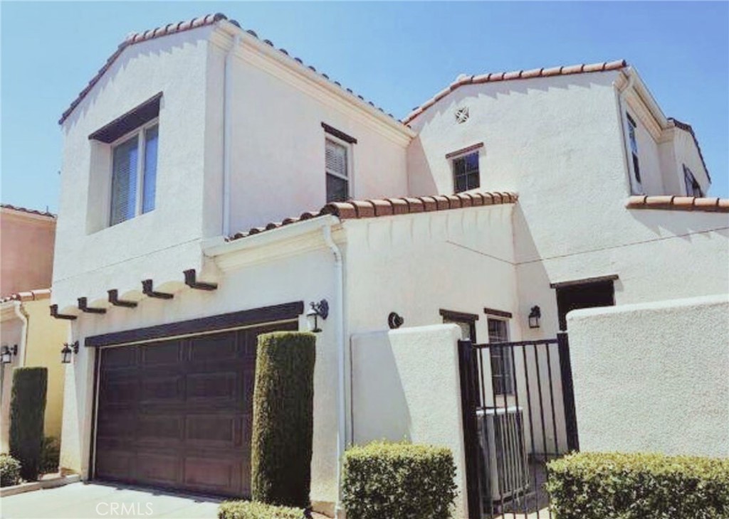 Located in the popular gated community of Tuscany in Porter Ranch, this affordable detached home offers 2 bedrooms and 2.5 bathrooms with 1,194 sq. ft. of living space. As one of the desirable roadside units, it features a bright first floor with tile flooring, an open living and dining area, powder room, and a modern kitchen with granite counters and stainless steel appliances. Upstairs are two spacious bedrooms, each with its own private bathroom, plus hallway storage and a built-in desk nook that’s perfect for working from home. The primary bedroom has a roomy walk-in closet and vanity, while the secondary bedroom includes a full bath and large closet. The attached two-car garage provides direct access and comes with a washer and dryer. The gated community offers great amenities including two secure entrances (one for residents only), a pool, spa, and BBQ area. Conveniently close to top-rated schools, The Vineyards shopping center, Porter Valley Country Club, and plenty of dining and entertainment, this home combines comfort, convenience, and affordability in Porter Ranch. Please note: some photos feature virtual staging. Minimum credit score 700 required.