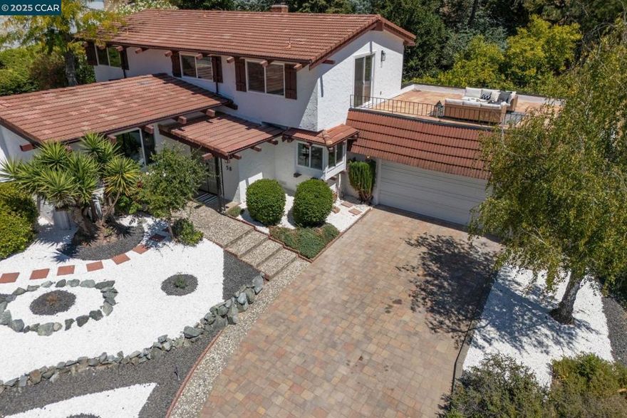 Price Improvement!  Spanish-Style Charm in Coveted Moraga Location - Positioned on a peaceful lot near the end of a quiet cul-de-sac, this two-story Spanish-style home offers approximately 2,420 square feet of stylish living on a generous .46± acre parcel. With four bedrooms and three full baths, the residence blends timeless character with modern updates, including a remodeled kitchen with new white cabinetry, gorgeous countertops, stainless steel appliances, subway tile backsplash, new flooring, and LED lighting (August 2025). The kitchen opens seamlessly to the family room and dining area, creating an inviting great-room feel, highlighted by hardwood floors and a wood-burning fireplace.    A spacious formal living room with vaulted ceilings offers a separate gathering space, ideal for entertaining. The primary bedroom opens to a large patio with sweeping views of the Moraga hills. Additional highlights include all new windows and sliding doors, an updated primary bathroom, fresh interior paint, new light fixtures, and new carpet (August 2025).  Located near Los Perales Elementary and other top-rated schools, the Moraga-Lafayette Trail, Moraga Country Club, and the Sunday Farmer’s Market, this home combines comfort, style, and an unbeatable location.