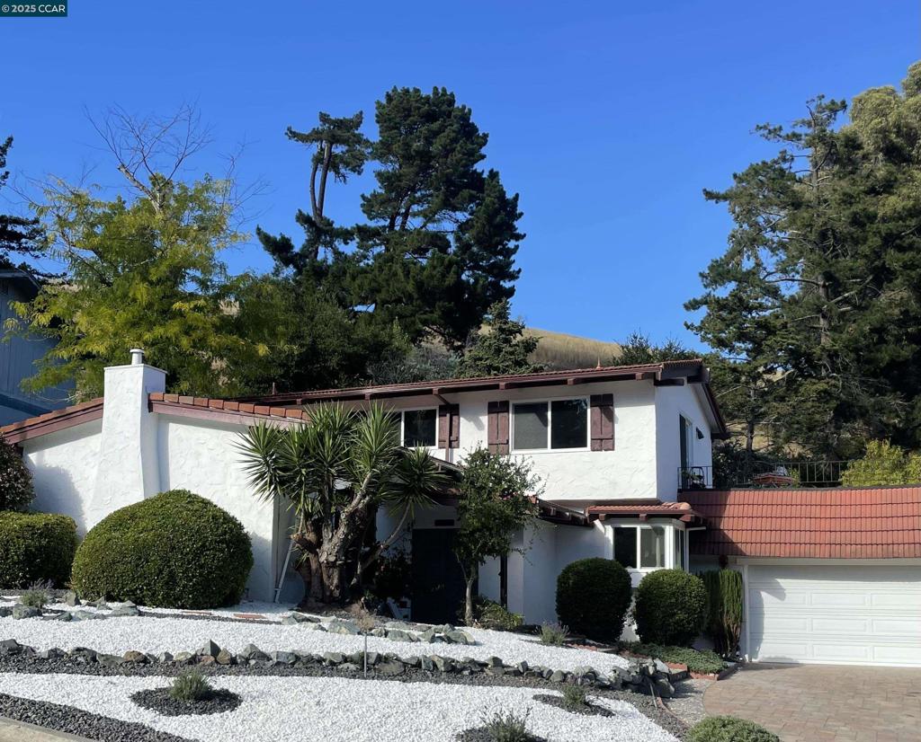 Just Listed! Spanish-Style Charm in Coveted Moraga Location - Positioned on a peaceful lot near the end of a quiet cul-de-sac, this two-story Spanish-style home offers approximately 2,420 square feet of stylish living on a generous .46± acre parcel. With four bedrooms and three full baths, the residence blends timeless character with modern updates, including a remodeled kitchen with new white cabinetry, gorgeous countertops, stainless steel appliances, subway tile backsplash, new flooring, and LED lighting (August 2025). The kitchen opens seamlessly to the family room and dining area, creating an inviting great-room feel, highlighted by hardwood floors and a wood-burning fireplace. A spacious formal living room with vaulted ceilings offers a separate gathering space, ideal for entertaining. The primary bedroom opens to a large patio with sweeping views of the Moraga hills. Additional highlights include all new windows and sliding doors, an updated primary bathroom, fresh interior paint, new light fixtures, and new carpet (August 2025). Located near Los Perales Elementary and other top-rated schools, the Moraga-Lafayette Trail, Moraga Country Club, and the Sunday Farmer’s Market, this home combines comfort, style, and an unbeatable location.