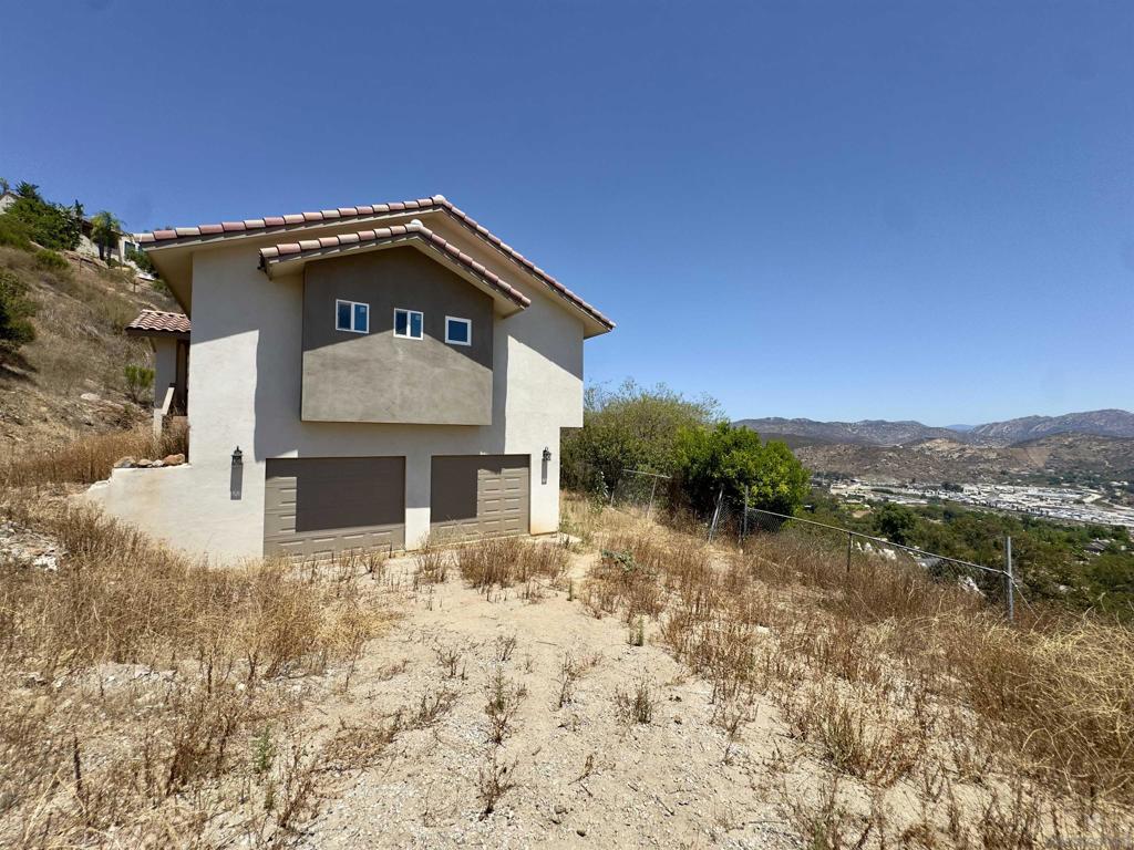 Rare REO investment opportunity in the scenic Eucalyptus Hills neighborhood of Lakeside. This 2023 new-build spans approx. 2,000 sq. ft. with 3 bedrooms and 3 bathrooms, situated across two parcels with expansive, unobstructed views. The home features a contemporary kitchen with modern finishes, and open-concept living areas. Interior construction is nearly complete— with bedroom flooring materials stored on-site or optional carpeting at buyer’s discretion. Site improvements remain unfinished, including driveway access, fire truck turnaround, and retaining wall grading. Engineering plans and previously approved permits are available but must be renewed. This property requires structural completion and is best suited for experienced cash buyers or contractors equipped to execute the final build-out. Not a cosmetic flip—this is a project with real vision and upside. Cash-only sale; buyer must provide proof of funds of $500K or more. Conveniently located near Manzanita Rd in a private hillside setting with proximity to Lakeside amenities and freeway access. Submit your bid starting at $350K and unlock this property’s full potential. Contact agent for full disclosures, engineering documentation, and walk-through and inspection Aug 8 & 9,2025 10AM-12PM. Offers are as-is final bid AUG 31st. Seller retains right to consider pre-emptive offers.