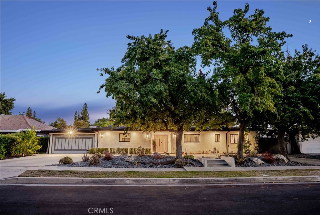Originally designed by renowned architect Charles Du Bois, this stunning single-story residence blends timeless mid-century design with modern contemporary comfort. Spanning over 2,600 square feet, the home welcomes you with a striking entry and a thoughtfully curated interior featuring recessed lighting, natural hardwood floors, and an effortless indoor-outdoor flow. The layout includes four spacious bedrooms and three bathrooms, including a luxurious primary suite with dual sinks, an oversized rain shower, and sliding doors that open to the serene outdoors. The living room is anchored by a classic fireplace and rich ceiling beams, with expansive sliding glass doors that open to the backyard oasis. The chef’s kitchen is a true showpiece, featuring a large island, quartz countertops, stainless steel appliances, and custom natural wood accents. Vaulted, beamed ceilings in both the kitchen and dining room enhance the sense of space and warmth, with all areas flowing seamlessly to the outdoor retreat. Designed for both relaxation and entertaining, the backyard includes a covered patio with skylights and ceiling fans, a sparkling pool and spa, built-in BBQ, fire pit, and a generous lawn. Additional highlights include a two-car garage, circular driveway, and a beautifully landscaped front yard with mature trees. Ideally situated near parks, shopping, dining, entertainment, and major transit routes, this home offers the perfect balance of style, comfort, and convenience.