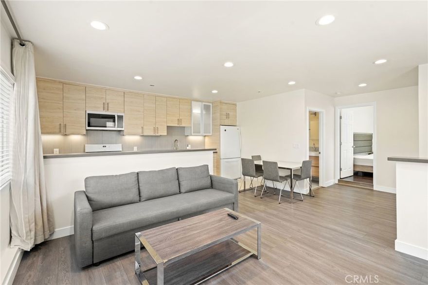 Charming and private, this 1-bedroom, 1-bath ADU is nestled in the heart of Granada Hills and offers its own separate entrance for ultimate privacy. Step inside to a cozy living room and dining area, highlighted by recessed lighting and sleek laminate flooring. The modern kitchen features quartz countertops, ample cabinetry, and a stylish backsplash. Comfort is ensured year-round with energy-efficient split AC units. The bedroom offers a peaceful retreat, and the updated bathroom is thoughtfully designed. A convenient in-unit washer and dryer adds practicality, while the private patio area provides a perfect outdoor space for relaxing.