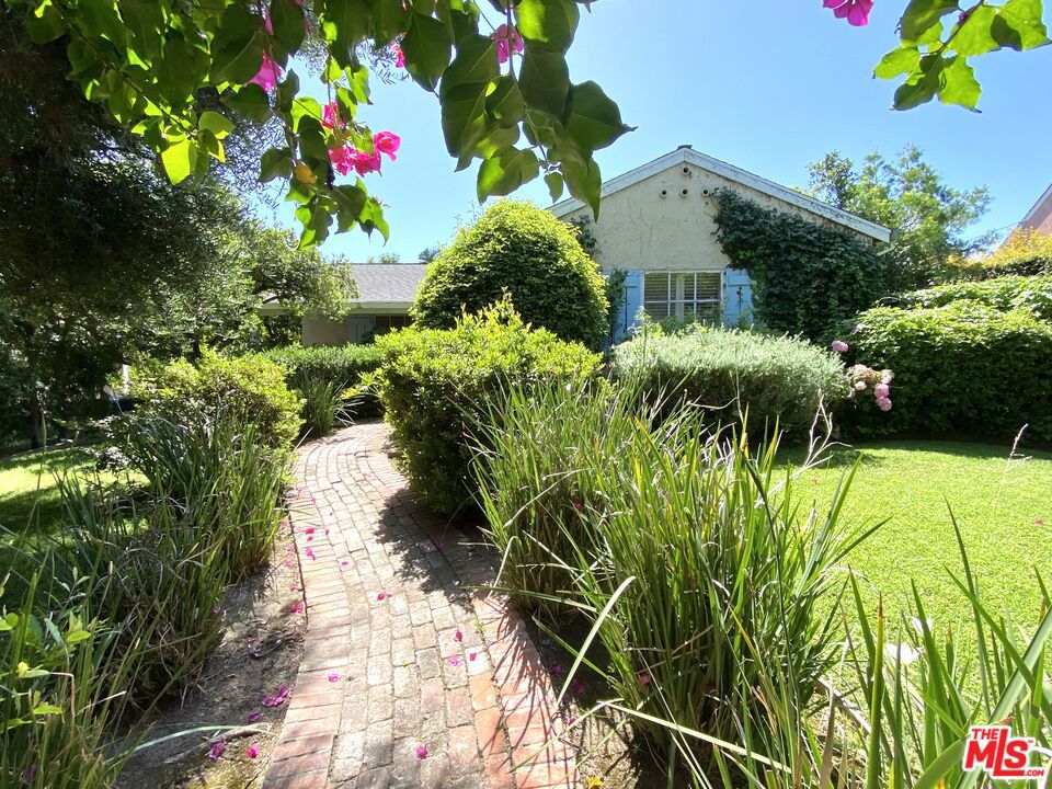 This charming 1938 2 Bedroom 1.5 bathroom house with bonus family room is located in one the prettiest and most desirable area of Altadena's Presidents neighborhood. In the large, fully landscaped, backyard you will find a studio apartment ADU with high ceilings, skylights, and its own fenced yard (The ADU has been generating nearly $2000 monthly income and will be delivered vacant). The main house is an oasis of privacy, calmness, and peace hidden behind a tall hedge and an incredibly lush front yard. A winding brick path leads from the street to a covered front porch. The house welcomes you to a generous 2 bedroom layout with original oak hardwood floors. The living room and adjoining family room share a two-sided wood burning fireplace that is the focal point of the house, especially during chilly winter evenings. While both the family room and formal dining room open to the nature outside to take full advantage of the warm climate. The large pergola offers an enchanting outdoor dining area all year round. The central air system was recently upgraded to four individual mini split units for better temperature control and efficiency. The main bathroom was renovated a few years ago but the kitchen and most wood windows could benefit from a future remodel. Very quiet and private home on almost 10,000 square foot lot. Gated driveway. Garden shed, workshop, and zen retreat area. No sign on the property. Easy to show on one day notice.