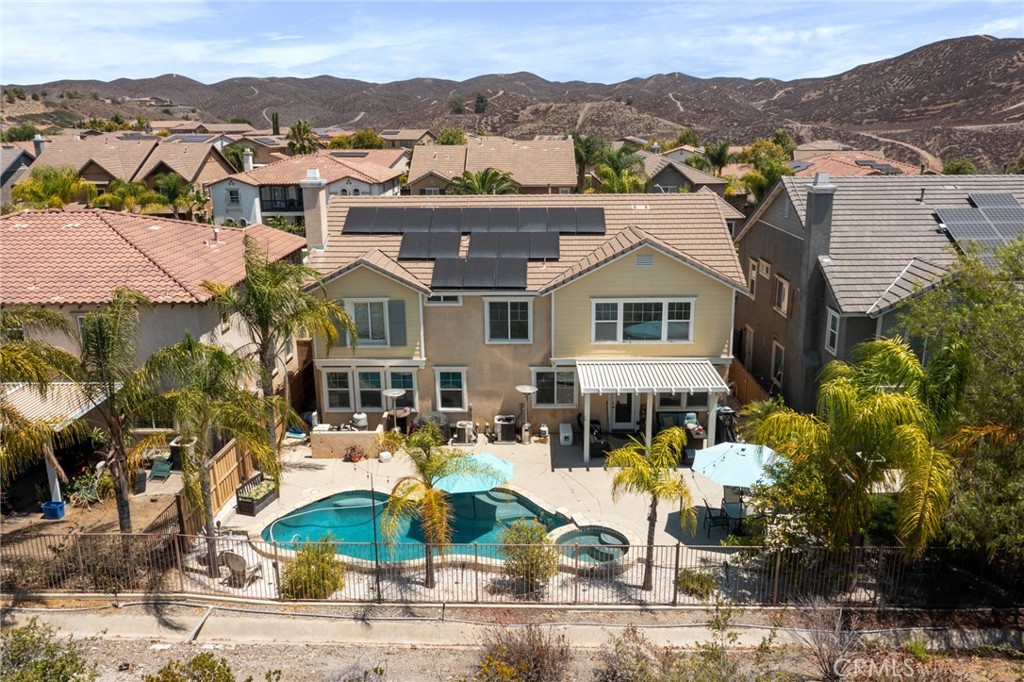 Welcome to this stunning 5-bedroom, 3-bath residence with a **Private Pool & Spa** in the highly sought-after **Rosetta Canyon community**. This home offers a perfect blend of comfort, style, and convenience, with a spacious layout designed for modern living.
Upon entering, you'll find a formal living room and dining room, ideal for hosting elegant dinners. The well-appointed kitchen is a chef's delight, boasting **granite countertops**, a **center island**, and a **breakfast bar**, all enhanced by recessed lighting and modern appliances. The kitchen seamlessly flows into the cozy family room, which features beautiful **wood floors** and a fireplace—perfect for relaxing evenings.
A significant highlight is the convenient **first-floor bedroom and full bathroom**, offering flexibility for guests or multi-generational living.
Upstairs, the home continues to impress with a large **loft space** and three additional bedrooms. The luxurious **master suite** is a true retreat, complete with a full bathroom featuring **his-and-hers closets**, two vanities, and an **oversized soaking tub**.
Step outside into your private oasis. The backyard is designed for both relaxation and entertainment, featuring a **sparkling pool and spa**—perfect for unwinding while watching the beautiful sunsets. The covered patio and concrete yard make it an ideal space for hosting gatherings.
The Rosetta Canyon community enhances your lifestyle with exceptional amenities, including a **23-acre park** with baseball fields, tennis and basketball courts, a dog park, and a picnic area with BBQ facilities. Plus, you'll be minutes away from shopping, dining, entertainment, and a **top-ranked elementary school**.