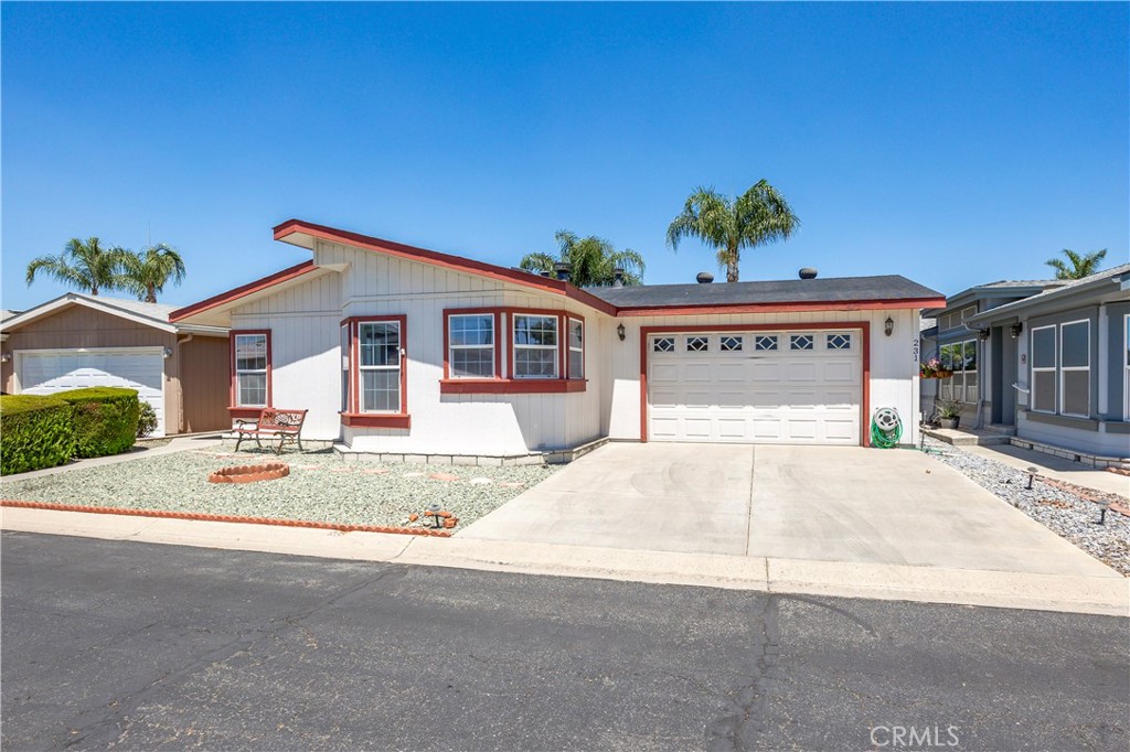1250 N Kirby St #231, Hemet, CA – Spacious & Upgraded Home with Rare 2-Car Garage in the Foothills of Hemet 55+ Community. Welcome to this beautifully maintained 2-bedroom, 2-bathroom home located in the highly desirable Foothills of Hemet, a gated 55+ community known for its peaceful setting and resort-style amenities. This spacious home stands out with tall ceilings, an open floorplan, and upgrades throughout. The large kitchen is a standout feature, offering a center island, abundant cabinetry, and a seamless flow into the formal dining room—perfect for entertaining. The oversized living area provides ample room to relax and enjoy the natural light that fills the space. The primary bedroom suite includes a bonus area ideal for a home office, craft space, or reading nook, along with a private bath and generous closet. The secondary bedroom and full guest bath are equally well-sized, and there's a convenient indoor laundry room for added functionality. A rare find in this community: this home boasts a full 2-car garage, available only in select homes in the back section of the park. This is an incredible bonus, especially on a land-leased lot, where garages of this size are uncommon. Enjoy the outdoors from the covered front porch or unwind in the low-maintenance yard. A private storage shed is also included. All this with a low monthly space rent of just $875! Residents of the Foothills of Hemet enjoy access to a pool, spa, clubhouse, fitness center, billiards, and a vibrant calendar of social activities. Conveniently located near shopping, restaurants, medical centers, and more. Don’t miss the opportunity to own this rare gem with exceptional features in one of Hemet’s most popular senior communities!