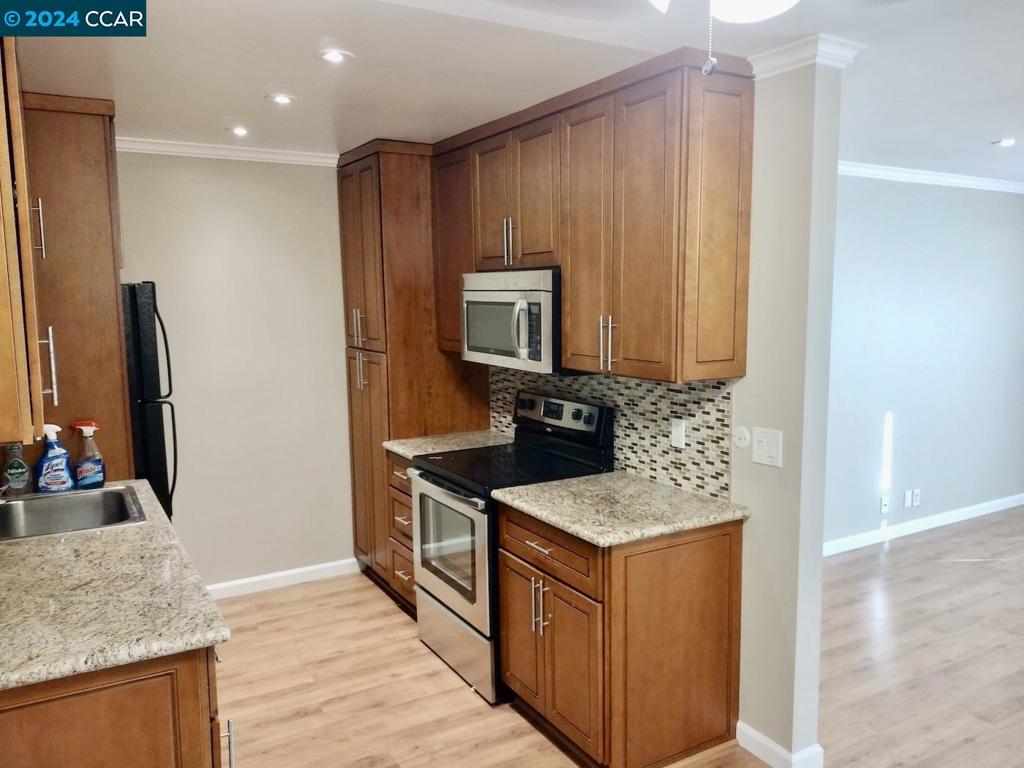 Condo is now vacant! Freshly painted, second-story condo updated with granite counters, cherry cabinetry, crown molding & baseboards and laminate floors. Refrigerator, microwave and electric stove. Primary Bedroom with walk-in closet. Large hall closet. Updated bathroom. Private Balcony. Desirable location near Diablo Hills 9-Hole Golf Course & The Greenery Clubhouse & Restaurant, John Muir Hospital, Shopping, Dining, BART Stations in Walnut Creek & Pleasant Hill, downtown Walnut Creek, Library, Iron Horse Trail, Heather Farm Park with Olympic pool, trails, soccer & baseball fields. Carport parking & guest parking, as well as street parking. Separate Storage Locker, Community pool, gym and BBQ area.