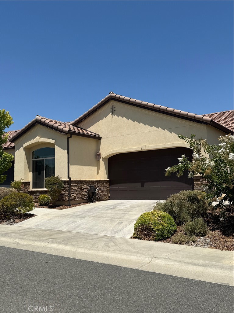 Thinking of down-sizing? This is your rare opportunity to own a home in Chico's newest and most exclusive 55+ neighborhood. Located within desirable California Park, this beautiful development allows residents to enjoy the best of all worlds: a wonderful feeling of privacy and security as well as a tremendous sense of community. Custom features include beautiful granite counter tops, tile roofing, luxury vinyl plank flooring, graceful arches, walk in pantry, and a gourmet kitchen with natural gas cooktop. The spa like primary bathroom is a retreat with its curb-less glass enclosed shower, separate garden bathtub, tile and granite. Greet your guests at the elegant foyer with spacious alcove and then entertain in the beautiful kitchen with abundant storage space, separate pantry, granite, and cherry finished cabinetry. The airy living room features a cozy natural gas fireplace. Whether you are relaxing on your patio or walking on one of California Park's many beautiful trails, you will enjoy this home and the Village Green neighborhood. There are 3 HOA's which ensure neighborhood appearance, and protect property values all while offering exclusive, private miles of walking trails, lakes and ponds. Located near medical centers, shopping, and desired east side Chico amenities, you will love living here. The Village Green over 55 subdivision is a rare offering. To top it off, the newer refrigerator, washer, dryer and flat screen tv are all included. Move in ready for you!