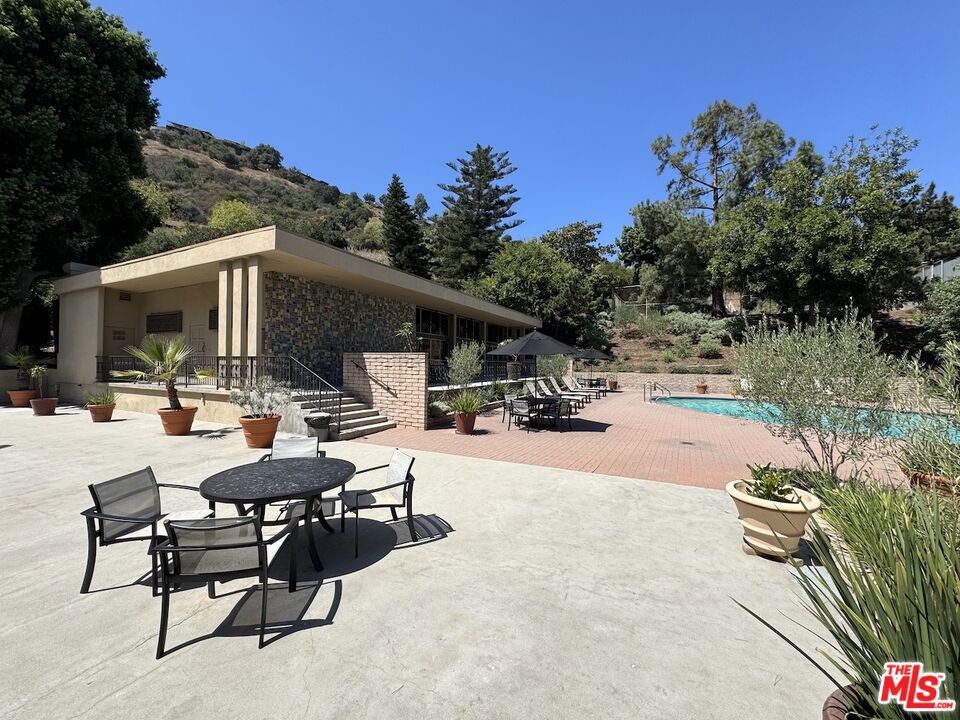 Welcome home to this updated 2-bedroom, 2-bath condo tucked within The Highlands, a hidden gem community just north of the Hollywood Bowl. Surrounded by lush greenery and serene hillside views, this home offers a rare blend of nature, tranquility and city convenience. Inside, you'll find a spacious layout featuring a large primary bedroom with generous closet space, freshly painted interiors and new flooring throughout; including new carpet in the living room and bedrooms. Expansive windows invite natural light and frame peaceful tree-filled views, while your private balcony is the perfect spot to relax and soak in the hillside oasis. The Highlands community spans nearly 14 acres and boasts an impressive list of resort-style amenities: two swimming pools, spa, four saunas, tennis and pickleball courts, fitness center with two gym areas, and a recreation room complete with kitchen, pool table, and ping pong. Additional highlights include two dedicated side-by-side parking spaces in a gated garage and ample guest parking on a quiet street. All this, just minutes from the Hollywood Bowl, Universal Studios, major studios, scenic hiking trails, and world-class dining, shopping and entertainment at Hollywood & Highland and Universal CityWalk. With easy access to the 101, commuting to Downtown or the Valley is a breeze. Experience the best of both worlds - tranquil hillside living with city excitement at your doorstep.