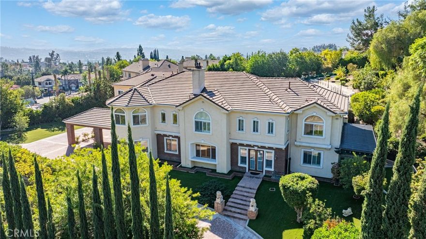 Welcome to a world of timeless elegance and refined sophistication. Tucked away in the prestigious Emerald Hills Estate community of Walnut, this magnificent custom-built mansion is a true architectural gem—designed for those who demand the very best in craftsmanship, privacy, and comfort.

A grand private gate and long sweeping driveway set the stage for this stately residence, offering over 9,094 square feet of opulent living space surrounded by other multi-million-dollar custom estates.

Grand Interiors. Step through the double doors into an impressive foyer crowned with a dazzling crystal chandelier and soaring ceilings that immediately evoke a sense of grandeur. The formal living room exudes warmth and elegance with its cathedral ceiling and fireplace, while the formal dining room provides an exquisite setting for hosting lavish gatherings.

The gourmet kitchen is a culinary showpiece, featuring granite countertops, a center island, and stainless-steel appliances—perfectly balancing beauty and functionality. A spacious family room with a custom wet bar offers the ideal backdrop for relaxed entertaining.

The mansion boasts total 8 bedrooms and 9 bathrooms, including six expansive bedroom suites, and two suites on the main level—ideal for guests or multi-generational living.

The primary suite defines indulgence, featuring a private sitting area, walk-in closet, romantic fireplace, and a spa-inspired bath retreat that rivals a five-star resort.

Entertainment & Relaxation. 

Every detail has been crafted for a lifestyle of leisure and sophistication.

The resort-style backyard is a true sanctuary—complete with a sparkling pool and spa, waterfall feature, full-size tennis court with lighted, outdoor BBQ pavilion, gazebo, and a tranquil Chinese-style garden surrounded by fruit trees and lush landscaping.

Exceptional Features

• Private elevator to all levels

• Four-zone central air and heating system

• Four-car garage with EV charging prewire

• Water softener system

• Sauna

• Central vacuum and advanced security system

• Professionally designed landscaping throughout. 

Set on a private and quiet cul-de-sac within the award-winning Walnut Valley Unified School District, this extraordinary residence offers both prestige and convenience—just minutes from fine dining, shopping, and major freeways. A rare opportunity to own one of Walnut's most distinguished estates.