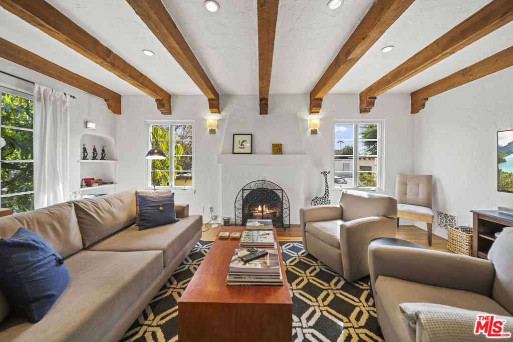 NEXT AVAILABLE AUGUST 1st. FULLY FURNISHED TURN KEY. LONG AND SHORT TERM RENTAL. Charming 1920s Spanish. Private light and bright with tree top views. Close to everything. Shopping, cafe's and West Hollywood nightlife. Quiet street on one of the best avenues in 90046. Upstairs duplex with stunning hardwood floors throughout. Formal living with beamed ceilings, gas fireplace with ceramic logs, 55" TV and Sonos sound, large dining room with seating for 6. Cook's kitchen, sunny breakfast room. Two large bedrooms, two baths with vintage tile. Dedicated private private gated front entry with yard, dining with BBQ and lounge area, additional upstairs private patio with views of the Hollywood Hills. Fully furnished, turn-key, fully stocked kitchen. Central HVAC. Full Size Washer Dryer. Short term offering will do 1- 3 month or longer term lease, wIll also consider small pet. Off street parking for one car in driveway, plus permit provided for extra street parking. Lease includes ALL utilities including high speed WiFi.